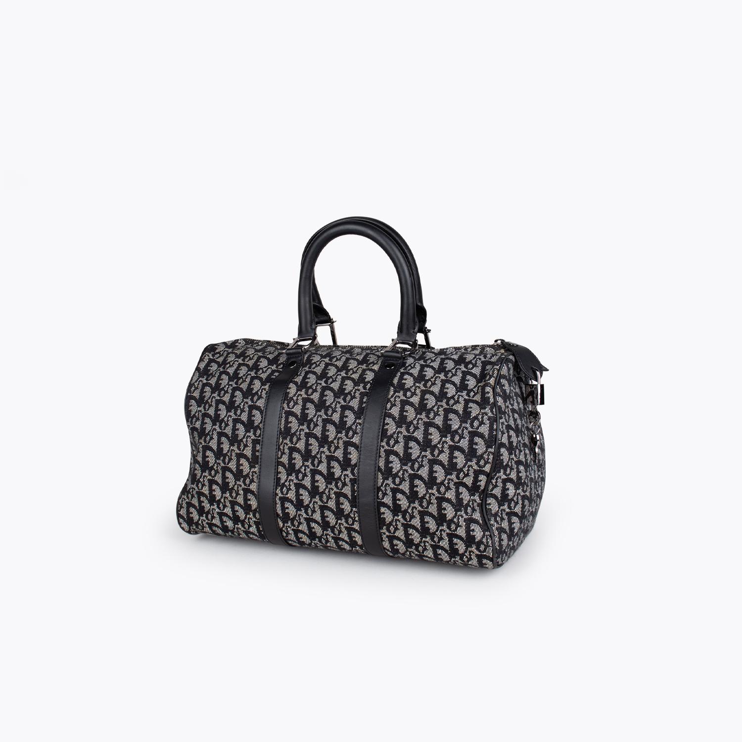 Black Diorissimo canvas Christian Dior Boston bag

- Silver-tone hardware
- Black leather trim
- Dual rolled top handles
- Tonal inner lining, single zip pocket at interior wall and zip closure at top

Overall Preloved Condition: Very Good. Minor
