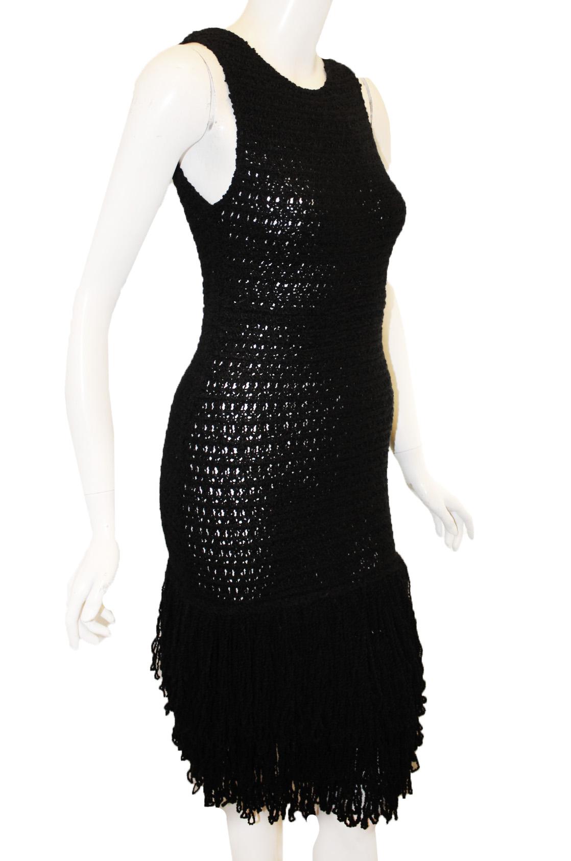 Christian Dior black alpaca wool sleeveless crochet runway dress with round neckline and overlapped wool yarn looped to form fringe all around the hem.  This dress in unlined giving this dress a see through appearance, but, you can always wear a