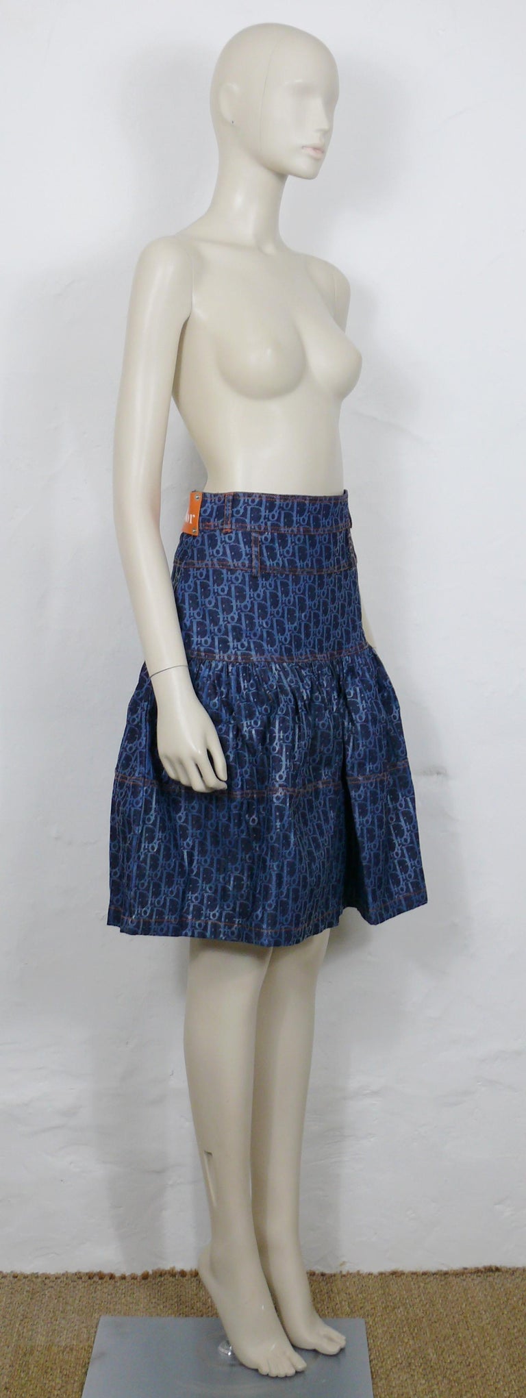 CHRISTIAN DIOR by JOHN GALLIANO vintage blue trotter monogram denim skater skirt.

This skirt features :
- Blue denim featuring the iconic DIOR monogram trotter print in shiny blue shade.
- Skater shape.
- Orange stitching.
- Belt loops.
- Back