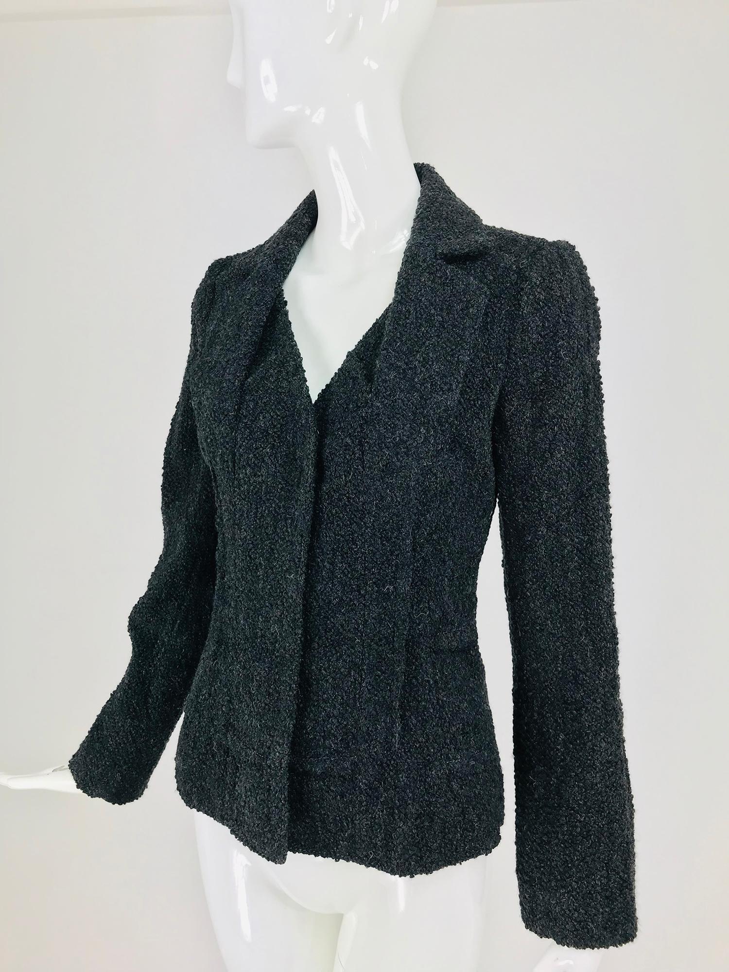 Christian Dior Boutique grey boucle outside seam jacket. Single breasted jacket closes with large hidden snaps. Long sleeves and bodice have outside seams. The lapels of the collar are not attached to the neckline but lay flat and give the jacket an