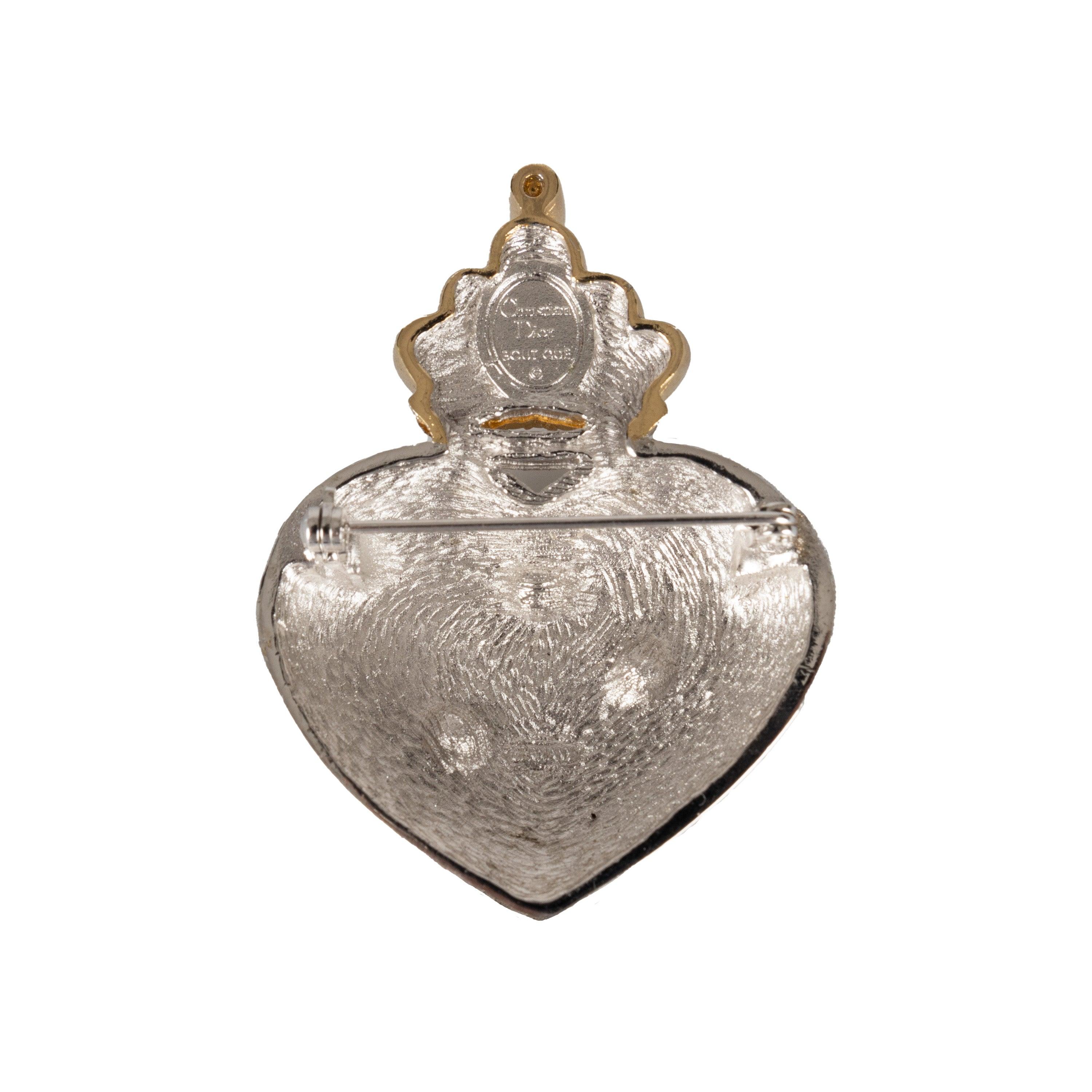 Bring some timeless glamour to your look with this classic Christian Dior Boutique brooch. Featuring a silver and gold metal heart with the signature CD logo and a crown with rhinestones. From the iconic Gianfranco Ferré era, this exquisite piece is
