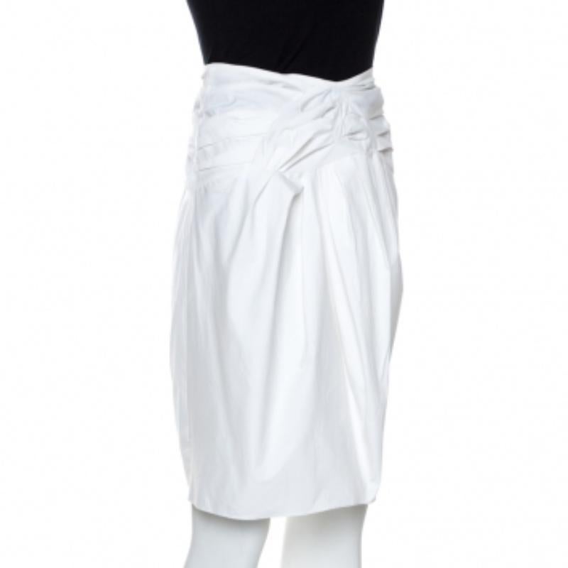 Christian Dior's skirt is a lovely piece to wear on calm summer evenings. It gives you a sophisticated and stylish feel. The skirt is excellently crafted in an amazing structure with bow detail on the front and a zipper fastening. The subtle white