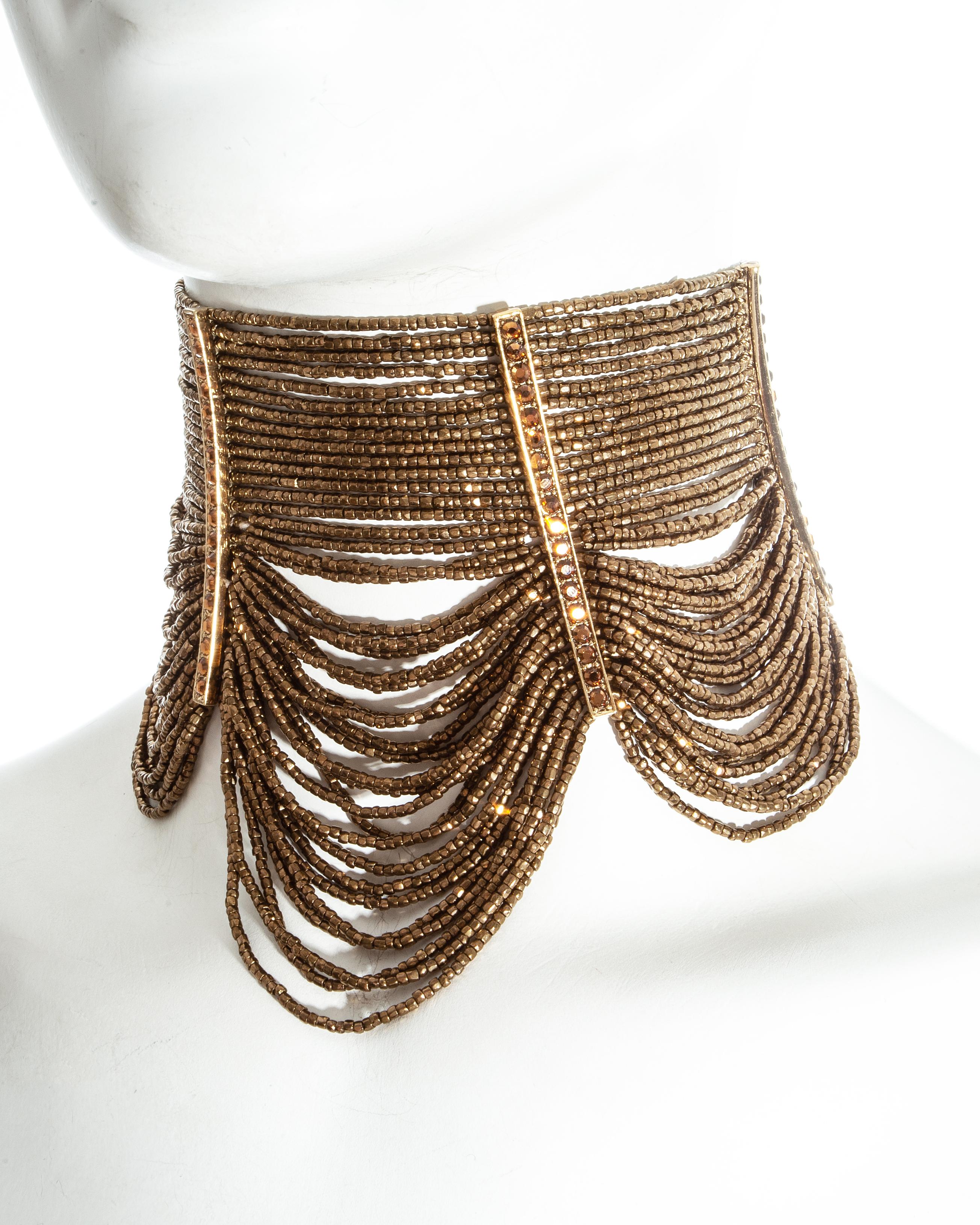 Christian Dior by John Galliano; three piece jewellery set. 

- 40 strand beaded Maasai choker necklace with link chain fastening and 6 gem encrusted panels
- 16 strand beaded bracelet with 4 gem encrusted panels 
- Bronze earrings with 1 large