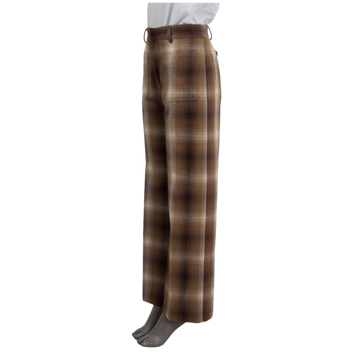 100% authentic Christian Dior wide-leg pants in brown and ivory check virgin wool (100%). Features two patch pockets on the front and two with buttons in the back. Closes with a concealed zipper and two hooks. Lined in silk (100%). Have been worn