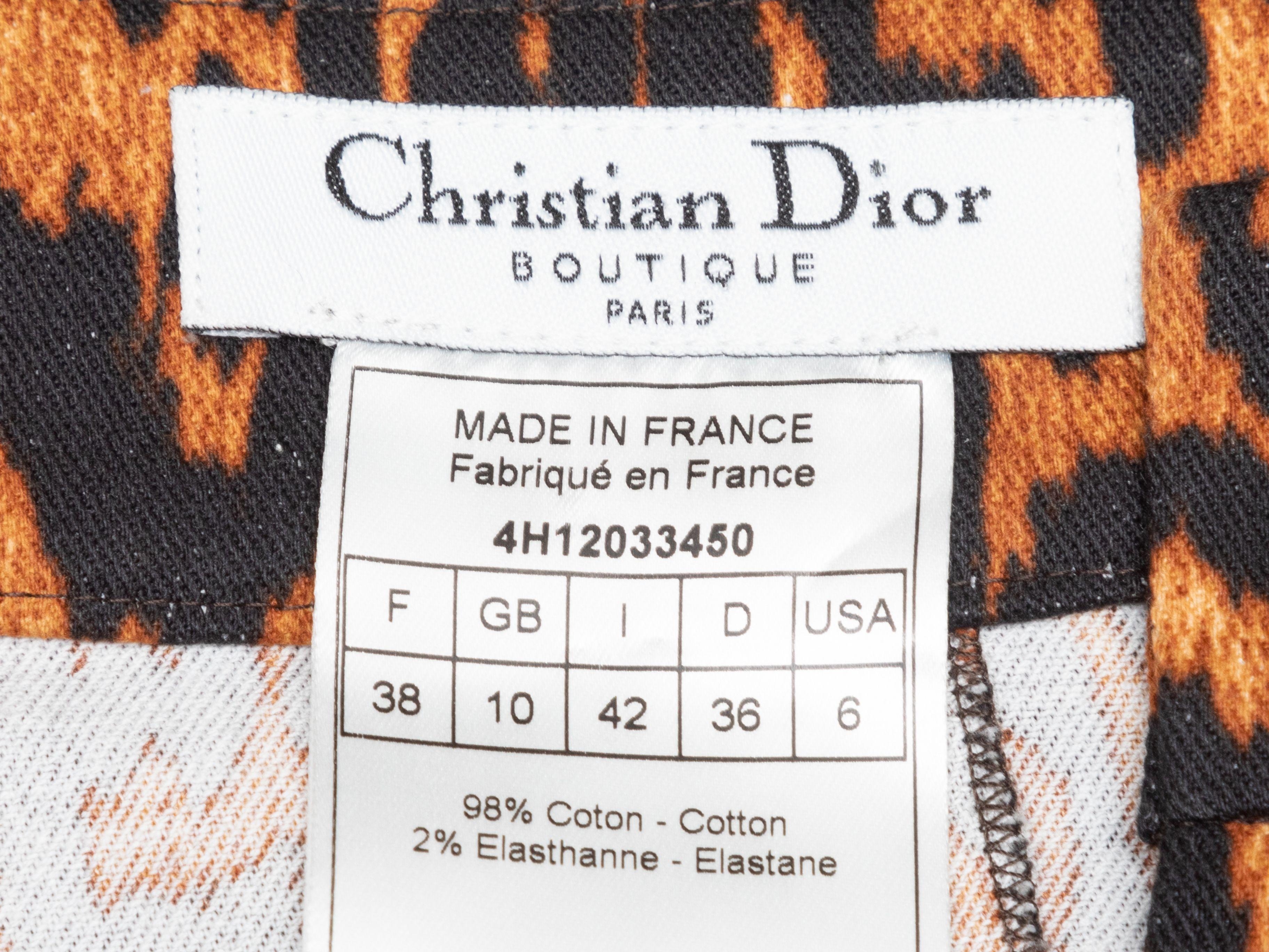 Product Details: Brown and black leopard print skirt by Christian Dior. Dual hip pockets. Front zip closure. 31