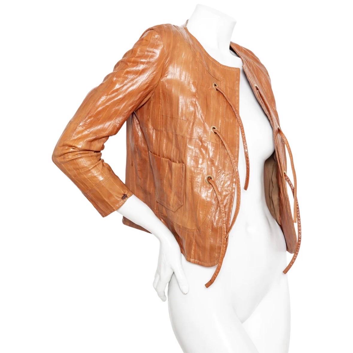 Christian Dior Brown Eel Leather Grommet Jacket

Vintage; circa early 2000s
John Galliano for Christian Dior
Light Brown
Eel leather panels
Collarless, round neckline
Open front with self-tie straps
Gold-tone grommets
Front patch pockets
3/4