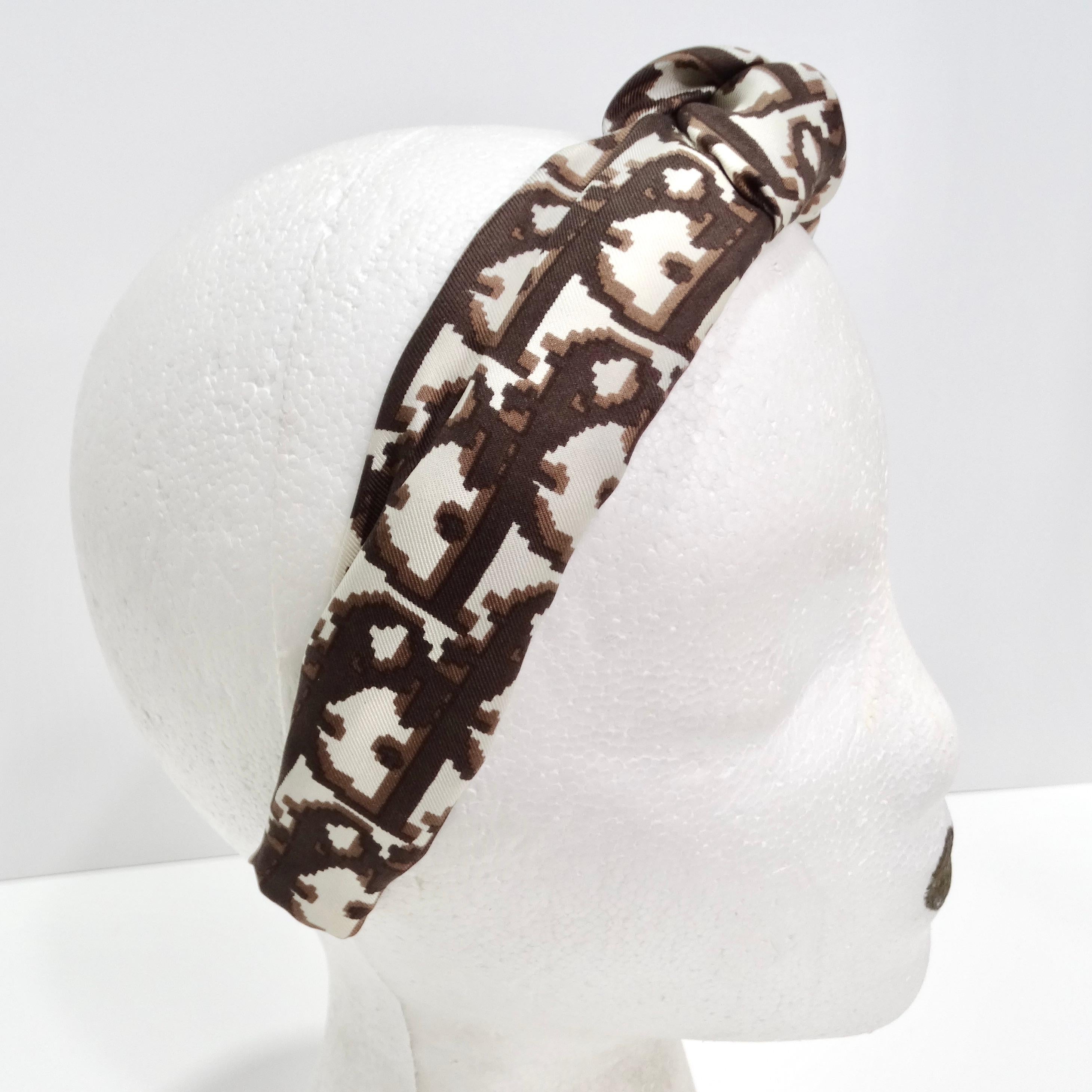Elevate your hairstyle with the Christian Dior Brown Monogram Knot Headband – a classic and sophisticated accessory that adds an elegant touch to your look. This thick headband sits gracefully at the ears and features a brown and white signature