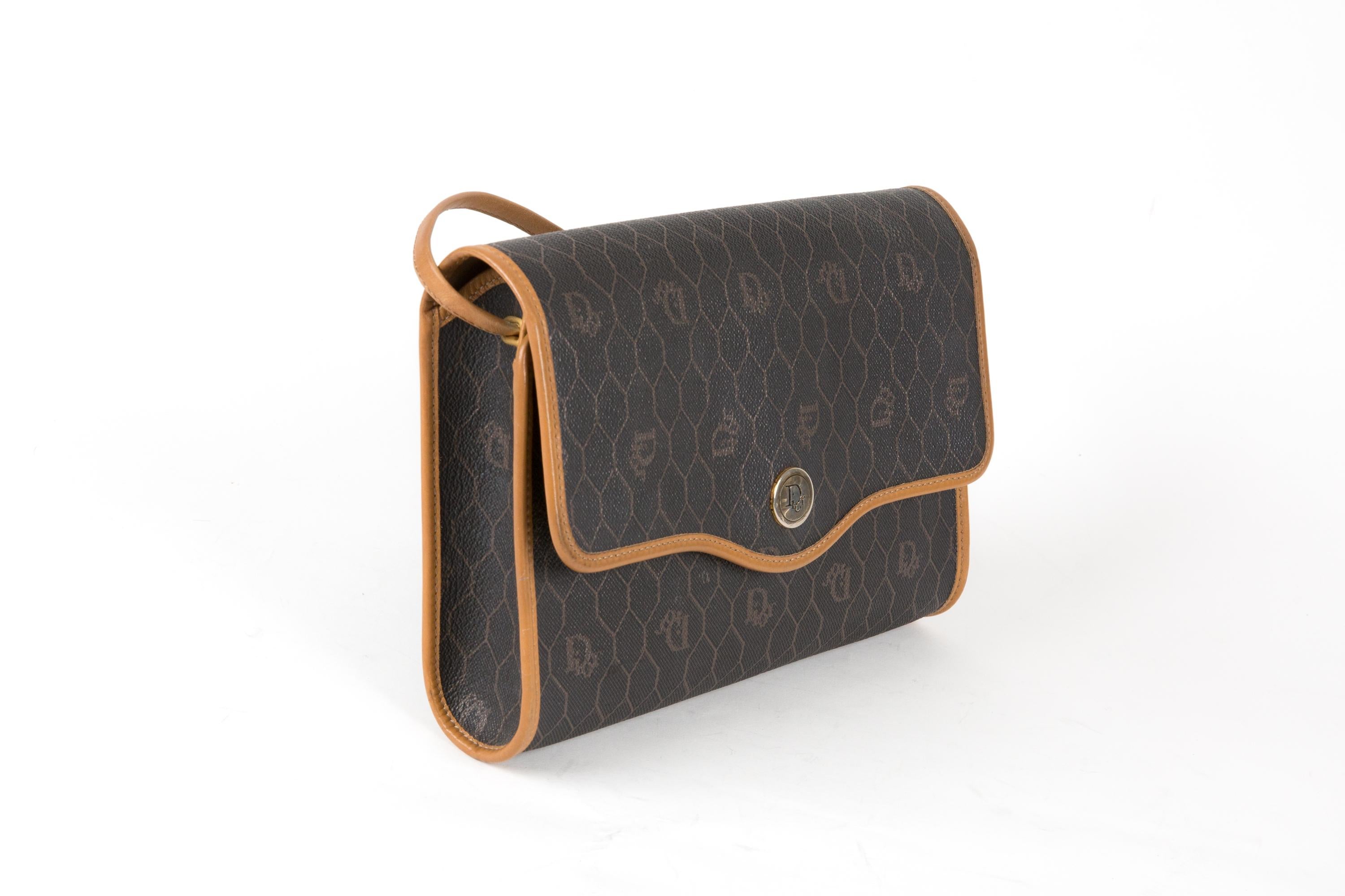 Christian Dior brown Monograme shoulder bag featuring a canvas monogram logo, a camel leather shoulder strap((Shoulder strap: 118cm) , gold hardware with front “Dior” snap closure, brown leather lining, an inside gold tone logo plaque. 
Circa 1980s 