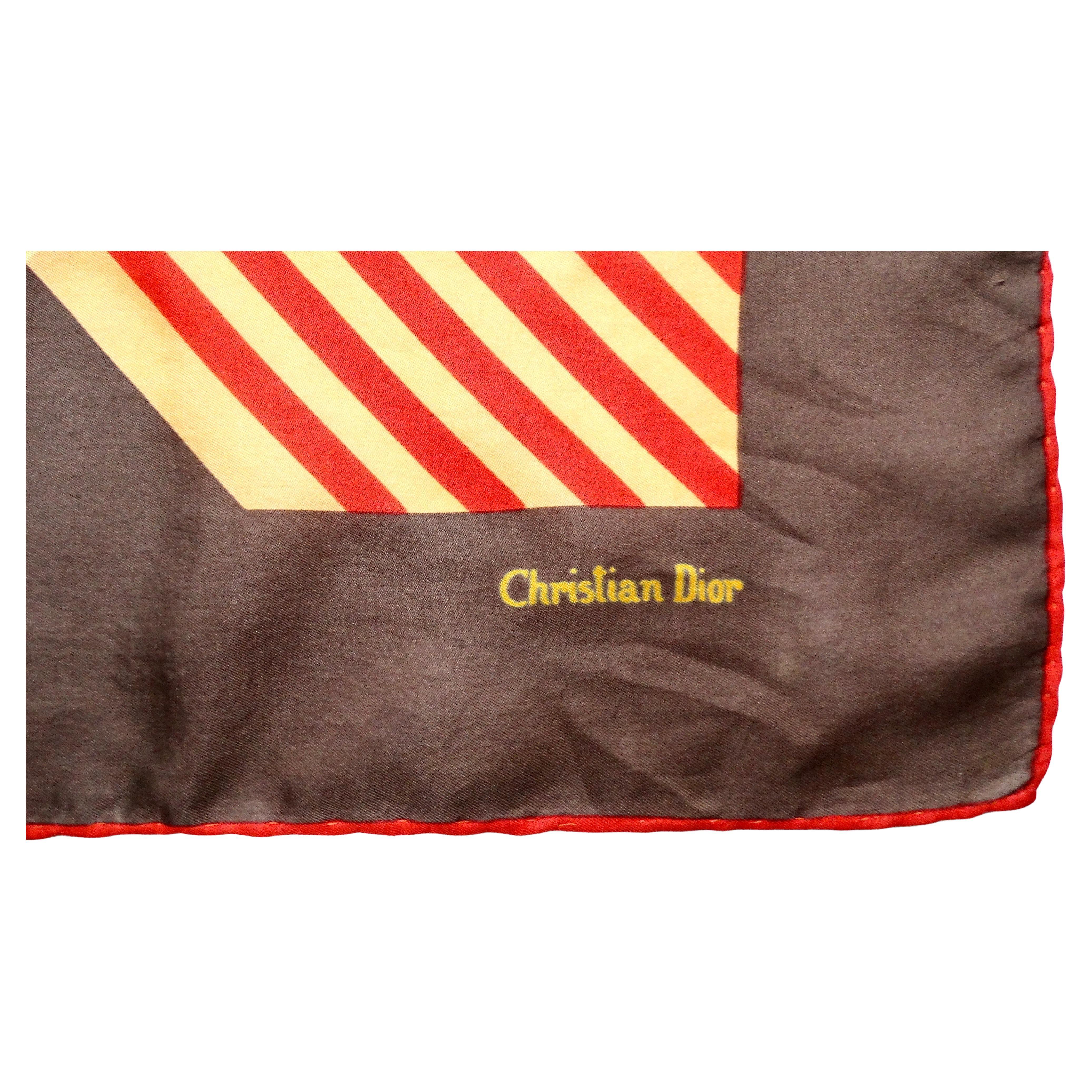 The Christian Dior Brown Silk Plaid Print Scarf from the circa 1970s is a timeless accessory that embodies the elegance and sophistication characteristic of the iconic fashion house. Crafted from luxurious silk, this scarf features a rich brown base