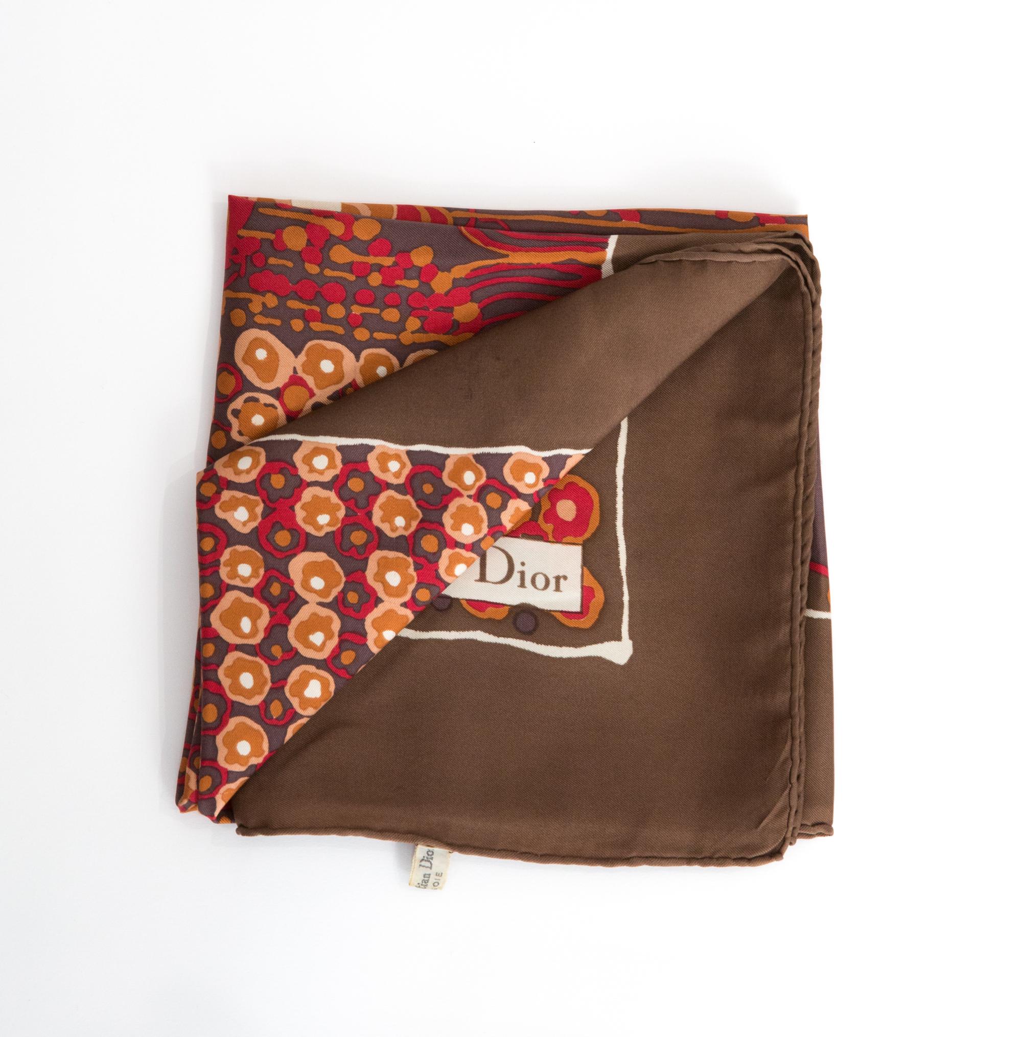 Christian Dior brown Silk Scarf featuring a brown border, a Christian Dior signature. 
Circa 1970s
In good vintage condition. Made in France.
29.5in. (75cm)  X 29.5in. (75cm)
We guarantee you will receive this  iconic item as described and showed on