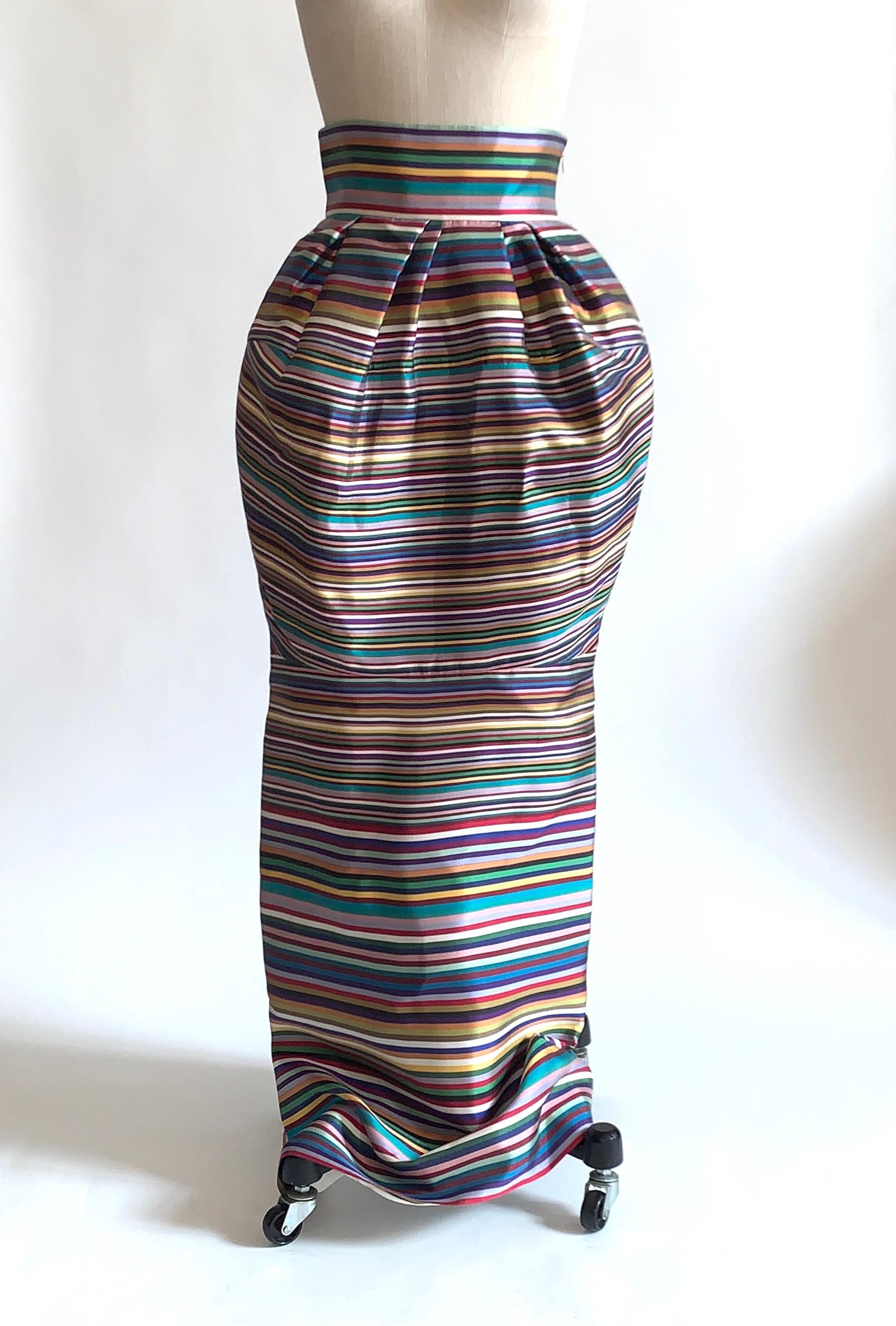 Christian Dior multicolor maxi skirt in a beautiful striped silk. Stripes in gold, purple, burgundy, green, navy and teal. Straight cut with voluminous bubble at hips. Side zip and hook and eye. 

Retailed at $4900.

100% silk.
Fully lined in 100%