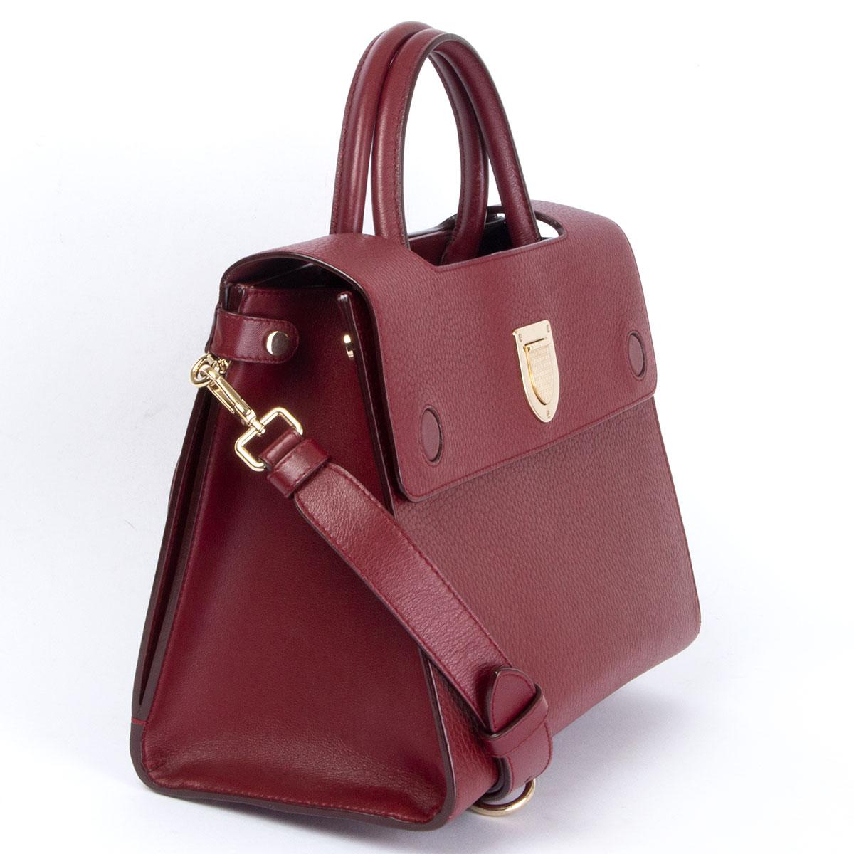 100% authentic Christian Dior Diorever Medium shoulder bag in burgundy grained leather. Opens with a magnetic flap closure and is lined in burgundy calfskin with three open pockets and one big open back pocket. Comes with a adjustable and detachable