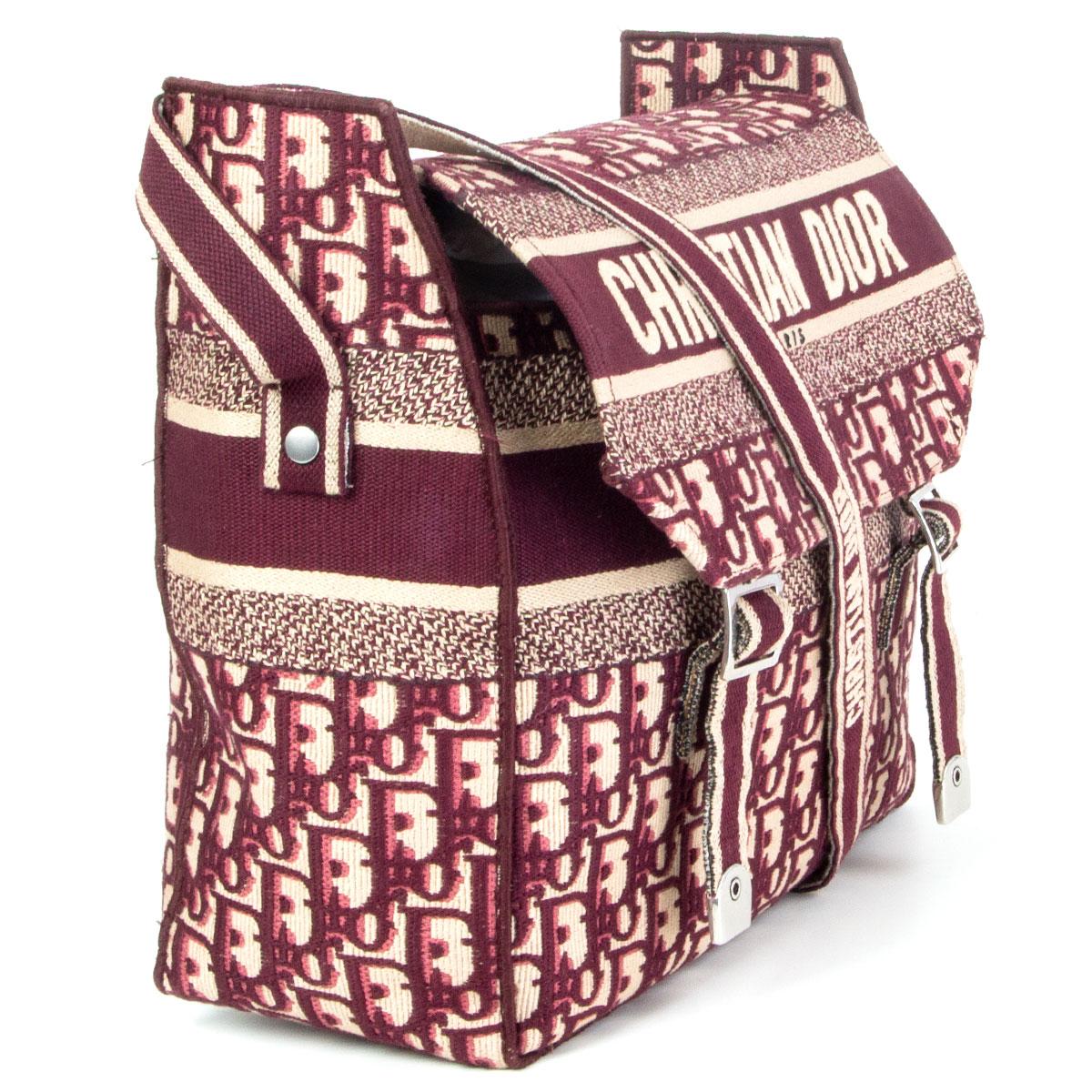 authentic Christian Dior Diorcamp messenger bag in burgundy Dior Oblique embroidered canvas. Opens with two buckles and a flap. Unlined. Has been carried and is in excellent condition. 

Height 28.5cm (11.1in)
Width 25cm (9.8in)
Depth 12cm