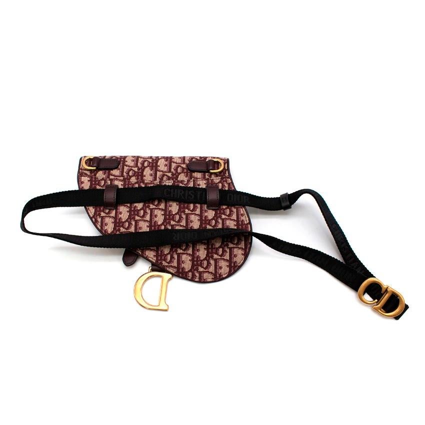 Christian Dior Burgundy Oblique Jacquard Mini Saddle Belt Bag
 

 - Allover deep burgundy and beige Oblique house monogram
 - Signature saddle shape, with hanging aged-gold tone D logo
 - Magnetic flap closure
 - Adjustable logo branded webbing