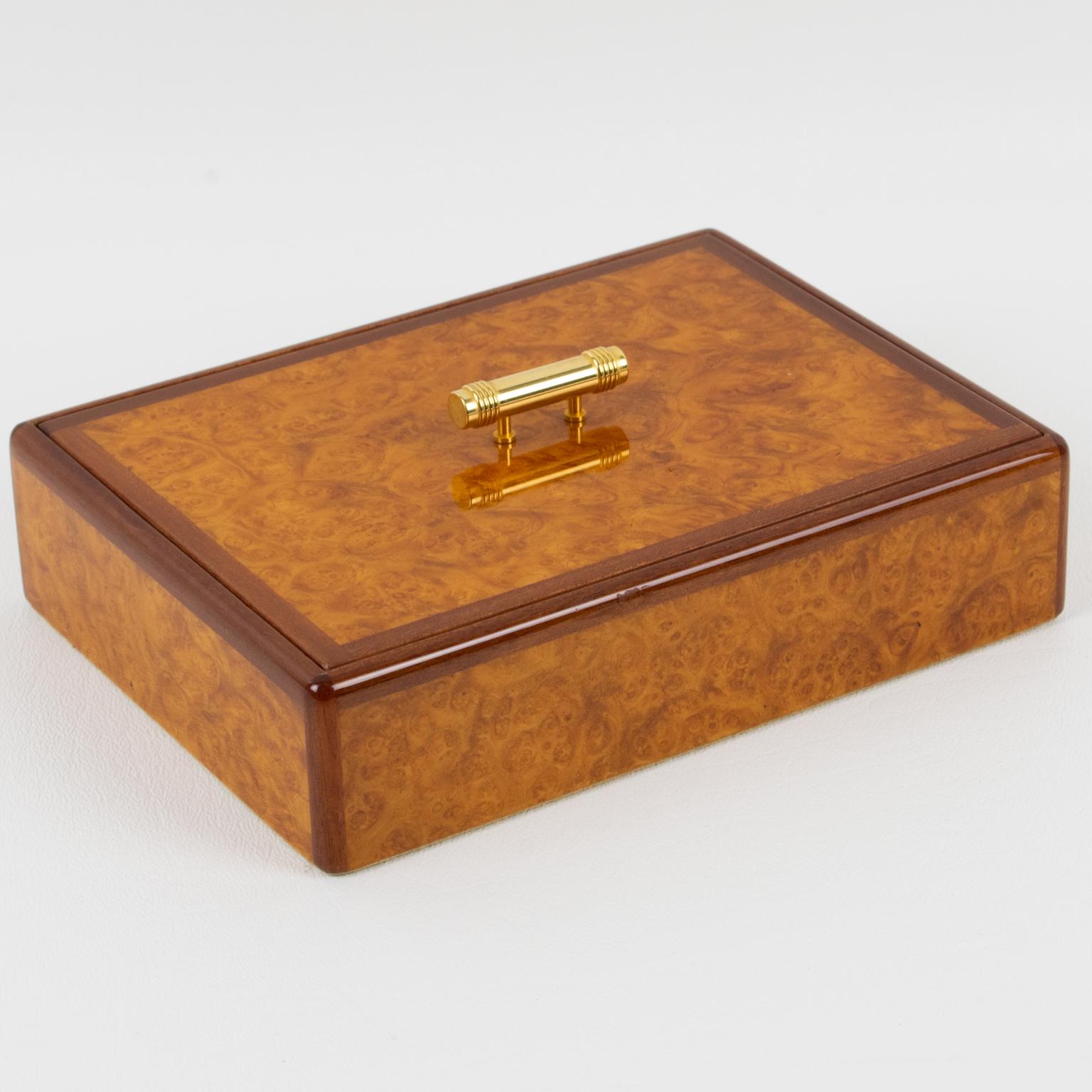 Beautiful Art-Deco-inspired decorative box designed for the Christian Dior Home Collection. Elegant minimal rectangular shape with high gloss burl wood and walnut wood detailing. A carved gilded brass handle is on the center of the lid. The interior