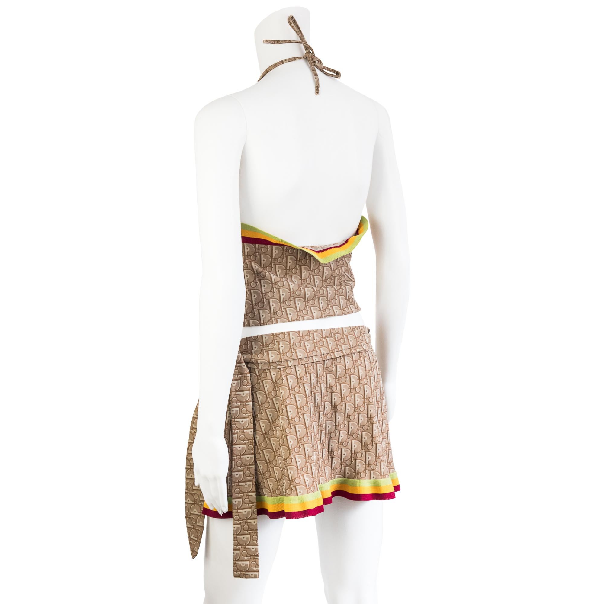 Ruder Than The Rest presents a Christian Dior by Galliano 2004 rasta collection halter top and pareo skirt set.

Both top and skirt feature the brown rasta monogram along with the red, gold and green elastic banding.

Top has a red buckle in the