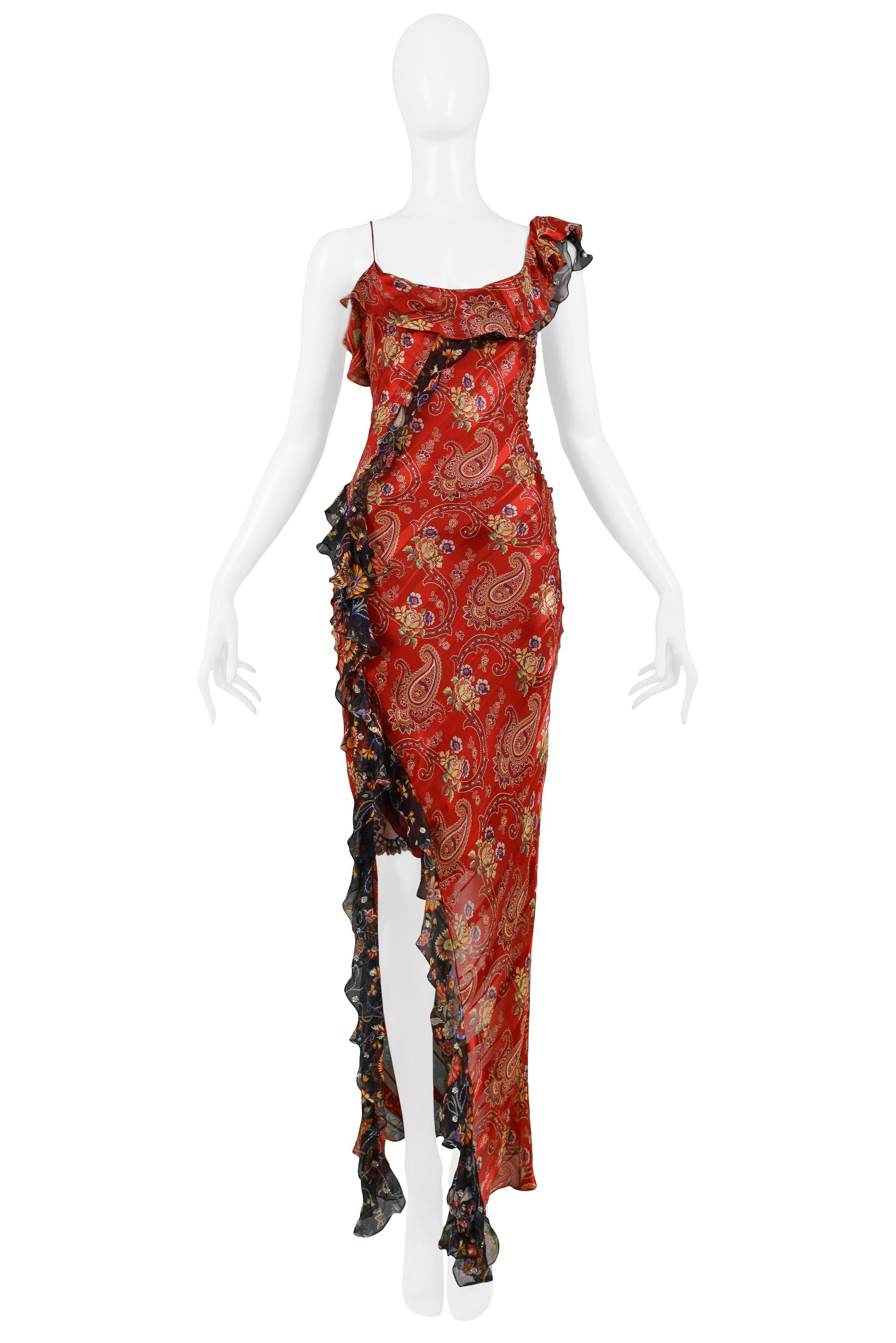 We are pleased to offer a vintage Christian Dior by John Galliano red paisley and floral asymmetrical evening gown featuring contrasting black floral chiffon ruffles, a low back, skinny strap, and side button closure.  

Christian Dior