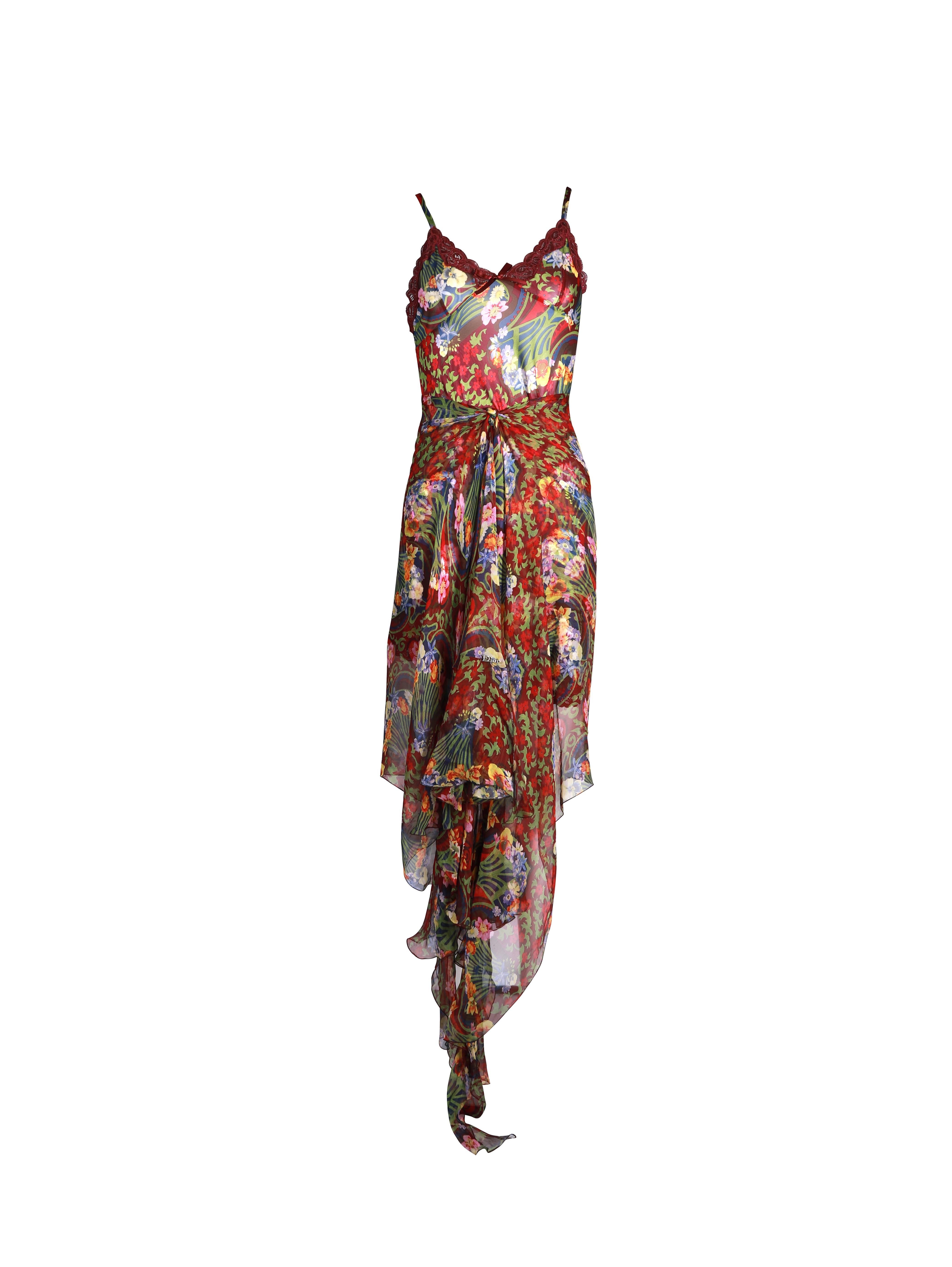 ▪ Christian Dior burgundy floral mini slip dress and sarong
▪ Designed by John Galliano
▪ Art Nouveau inspired floral print
▪ Lace trim
▪ Ribbon bow detail
▪ Twisted cut allows the fabric to ruche at the waist and create an asymmetric hemline
▪ FR