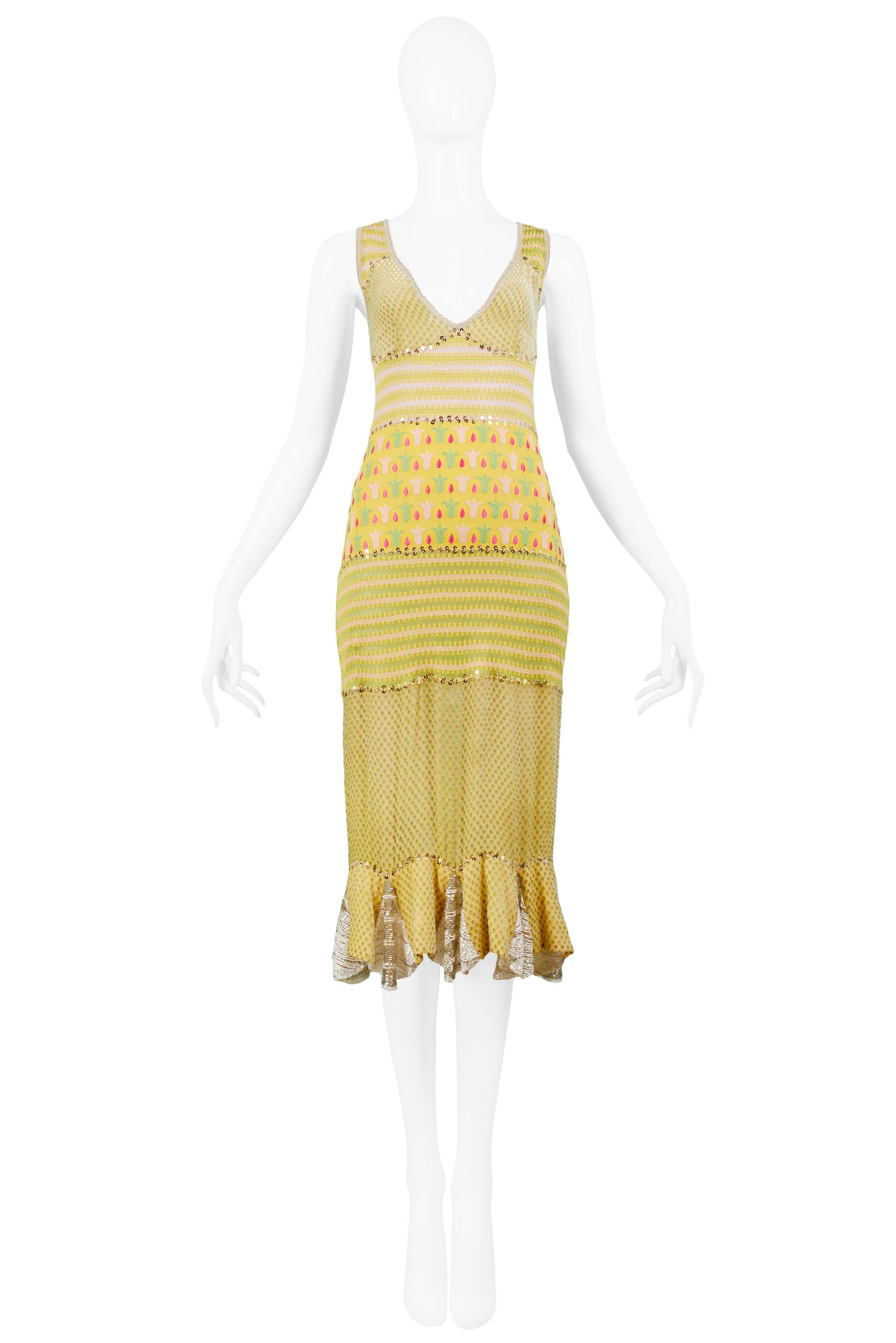 We are excited to offer a vintage Christian Dior by John Galliano pale yellow knit Spring day dress featuring red, pink and green floral embroidery, patchwork insets, shimmering gold sequin trim, and bugle bead panels, a sexy double cut-out back