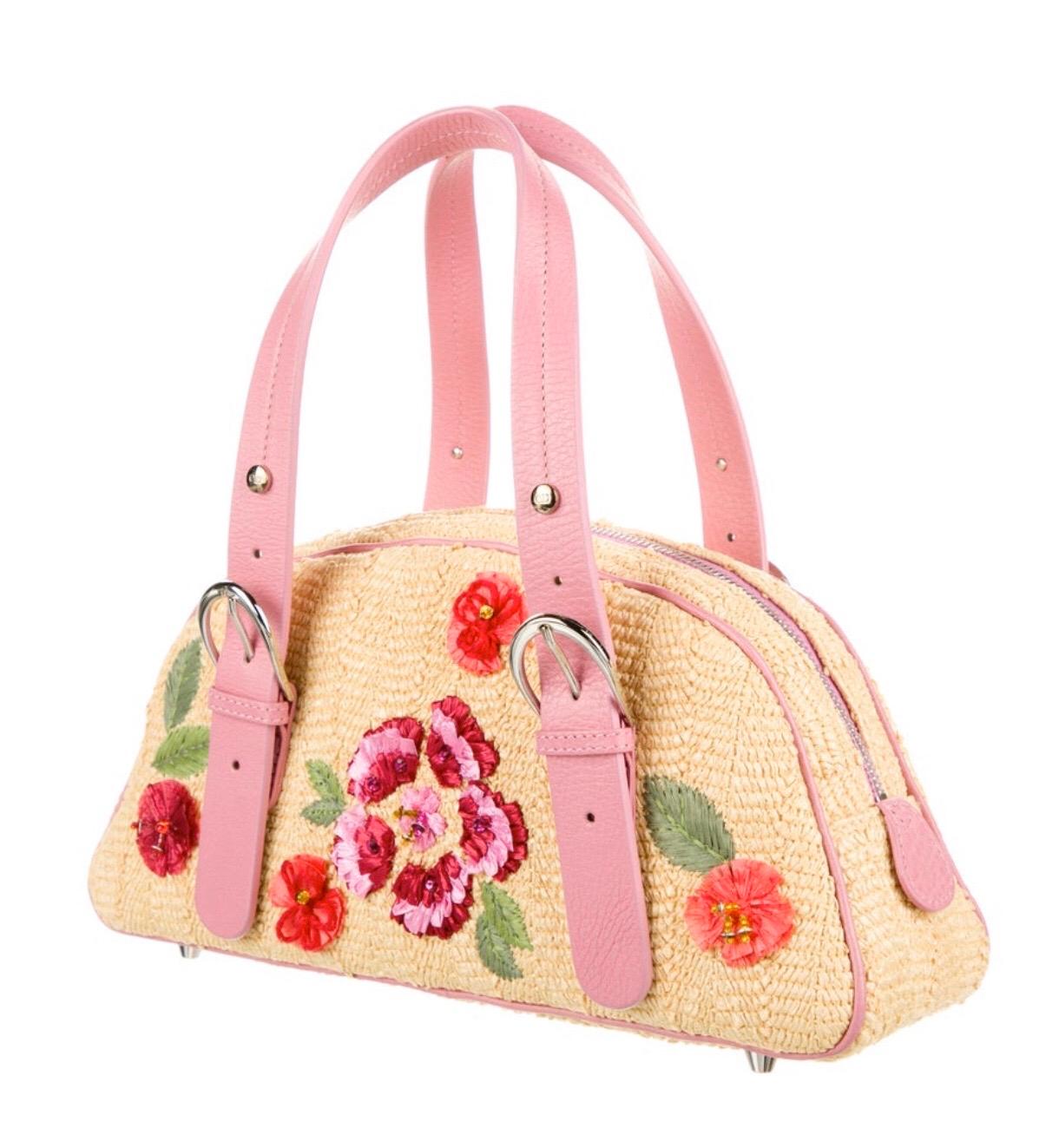 Christian Dior by Galliano straw handle bag with pink leather trim. Floral appliques. Condition:  Excellent. Looks new. 
