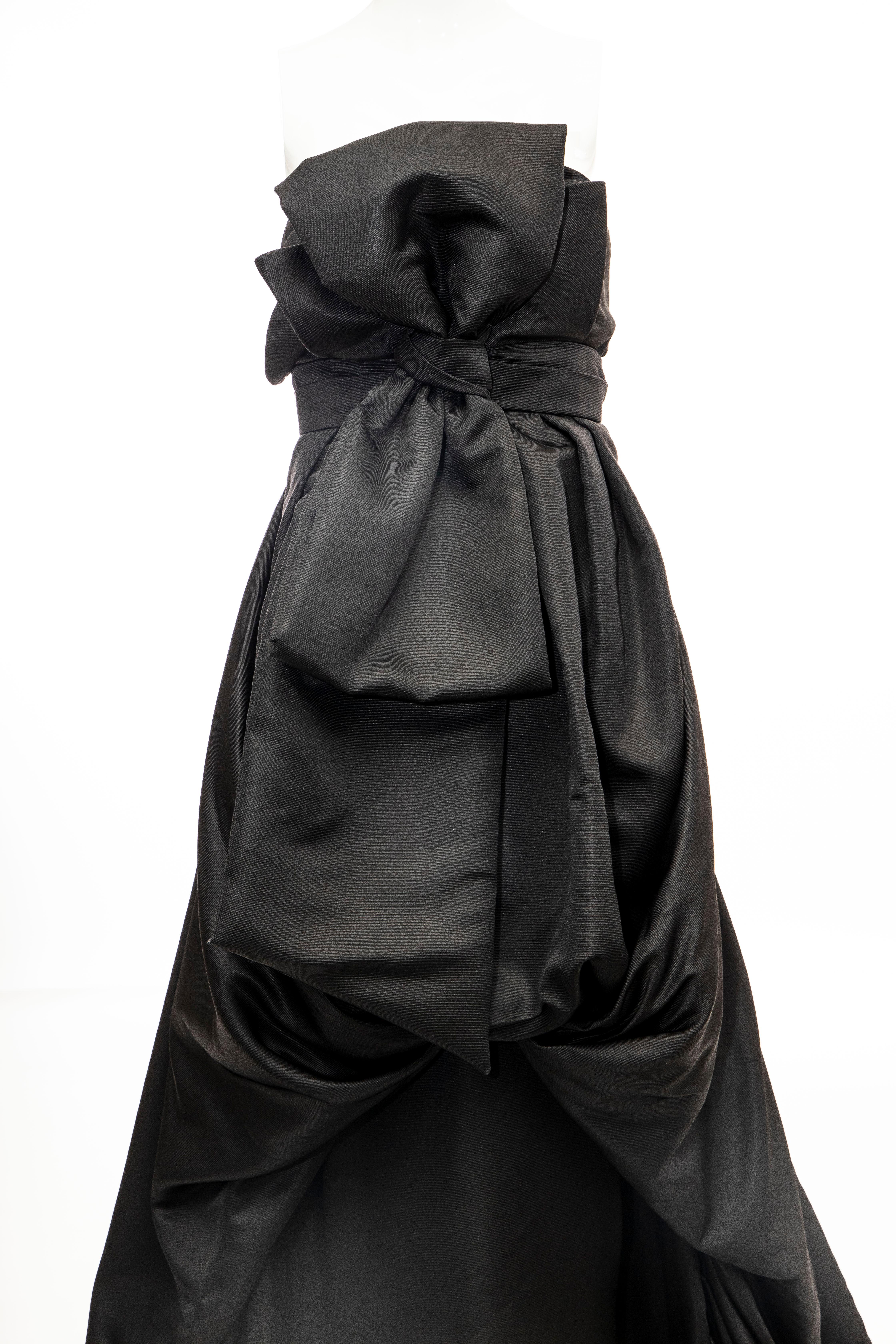 Christian Dior by John Galliano,  Fall 2008,  black silk strapless evening gown with bow accent at front; draped overlay, train at hem, inbuilt corset and concealed zip & snap closure at side. 


FR. 38, US. 6

Bust: 34, Waist: 31, Hip: 44, Length: