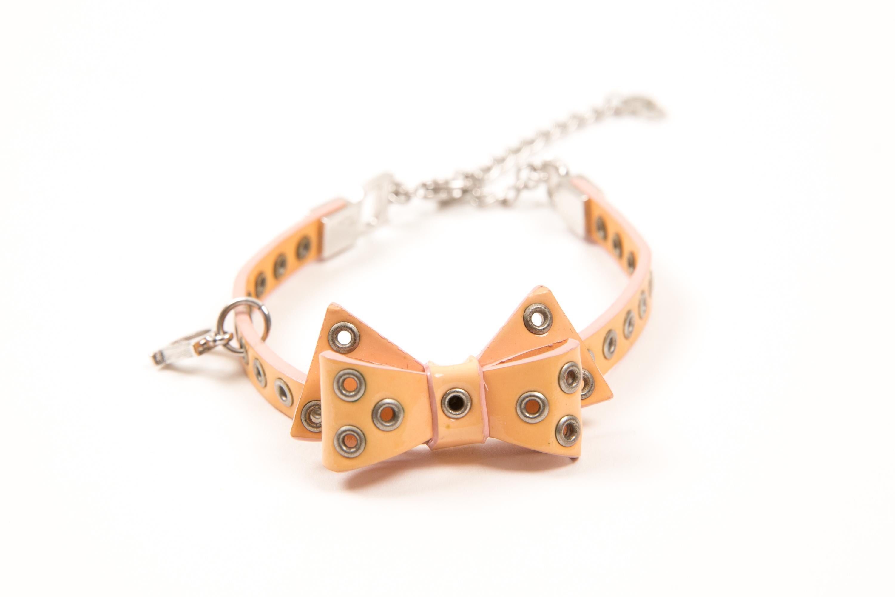 Christian Dior by John Galliano Peach patent leather tie bracelet silver-tone eyelet, a silver-tone chain with signature interlocking Dior logo and a a lobster claw fastening. 
In good vintage condition. Made in France.
Circa: 1990s
Maxi Length: