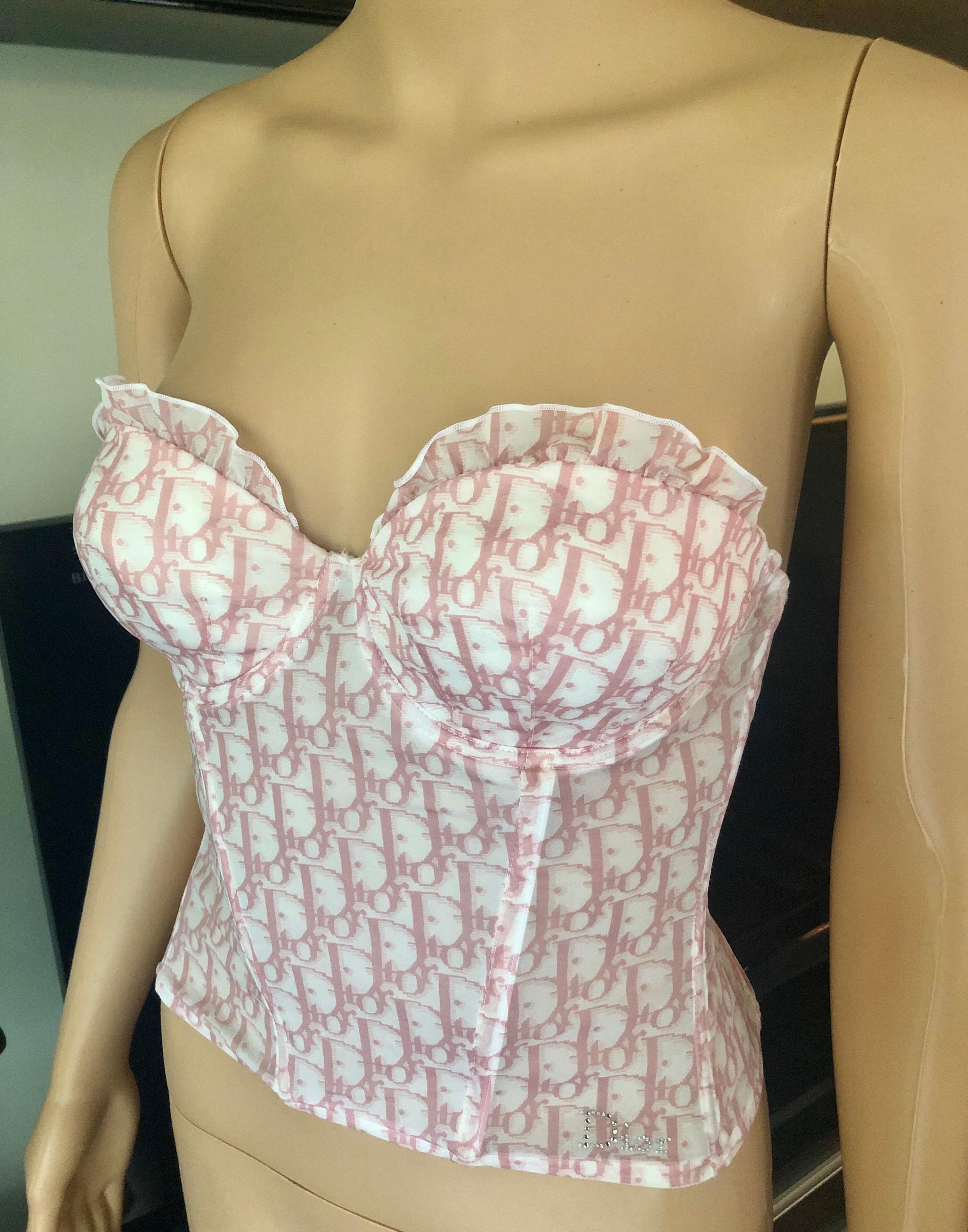 Christian Dior by John Galliano S/S 2003 Diorissimo Logo Monogram Sheer Bustier Top FR 36

Pink and white Christian Dior silk-blend semi-sheer bustier cropped top with Diorissimo monogram print throughout, rhinestone embellishments at front and