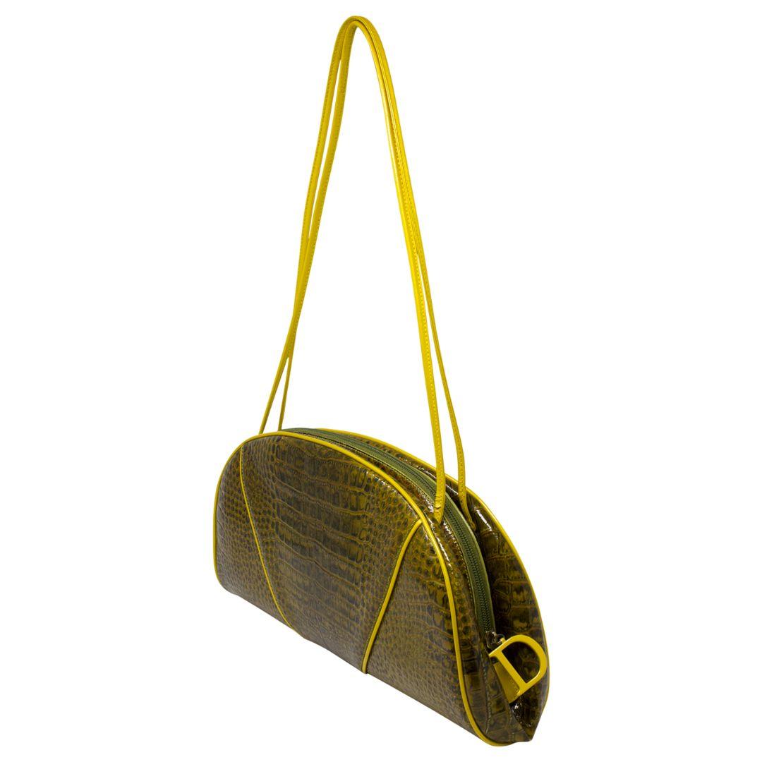This is a fashion icon! From the 2000 Collection by John Galliano, this Dior piece is crafted in yellow croc embossed leather, with fun tonal hardware, dual elongated shoulder straps, the D charm zippered closure opens up to a canvas yellow lining