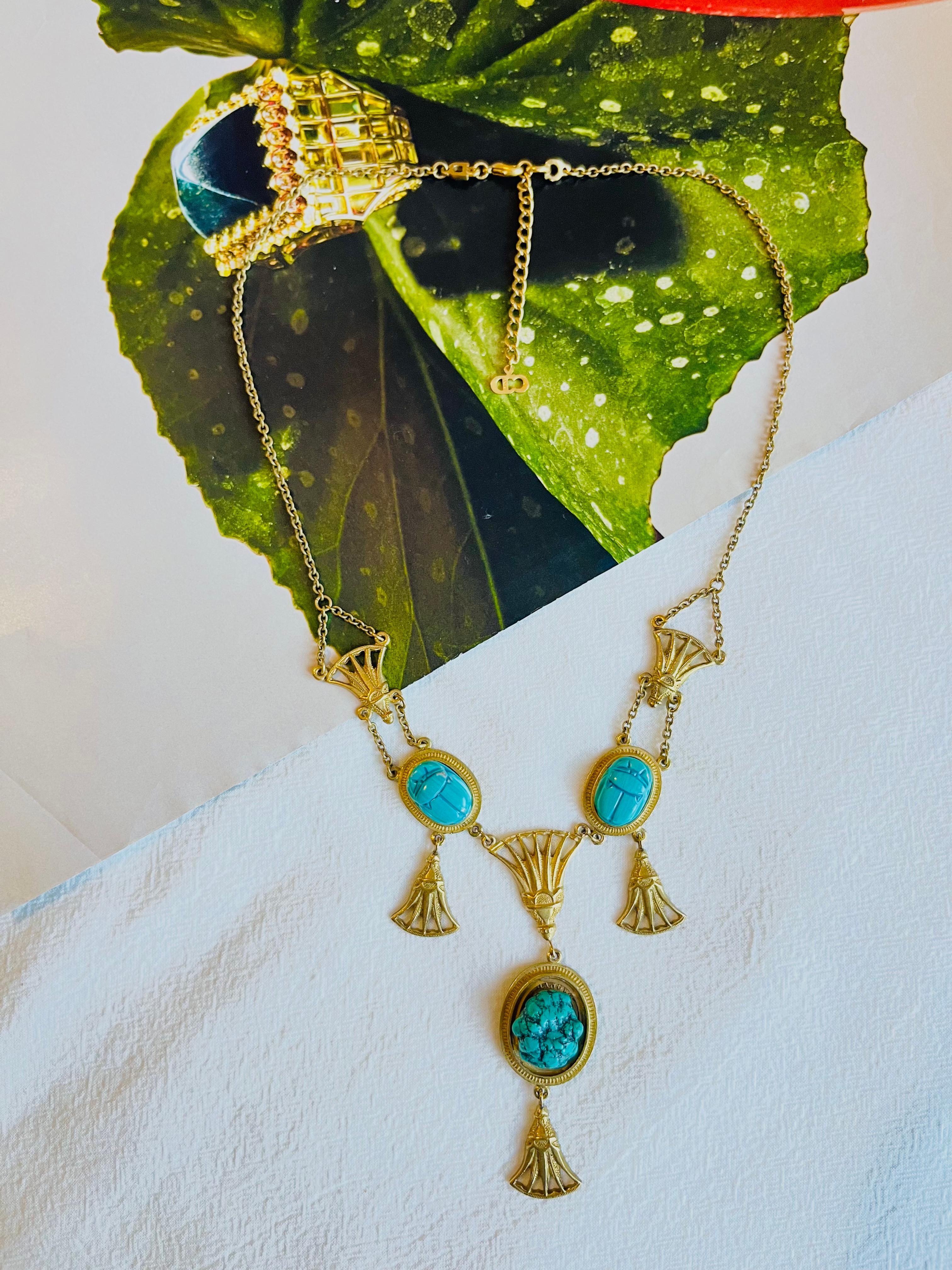 CHRISTIAN DIOR by John Galliano 2004 Egyptian Revival Turquoise Scarab Chandelier Fans Long Necklace, Gold Tone

Very good condition. The largest oval pendant has been changed to a turquoise. 100% Genuine. 

The token appears to have been added at a