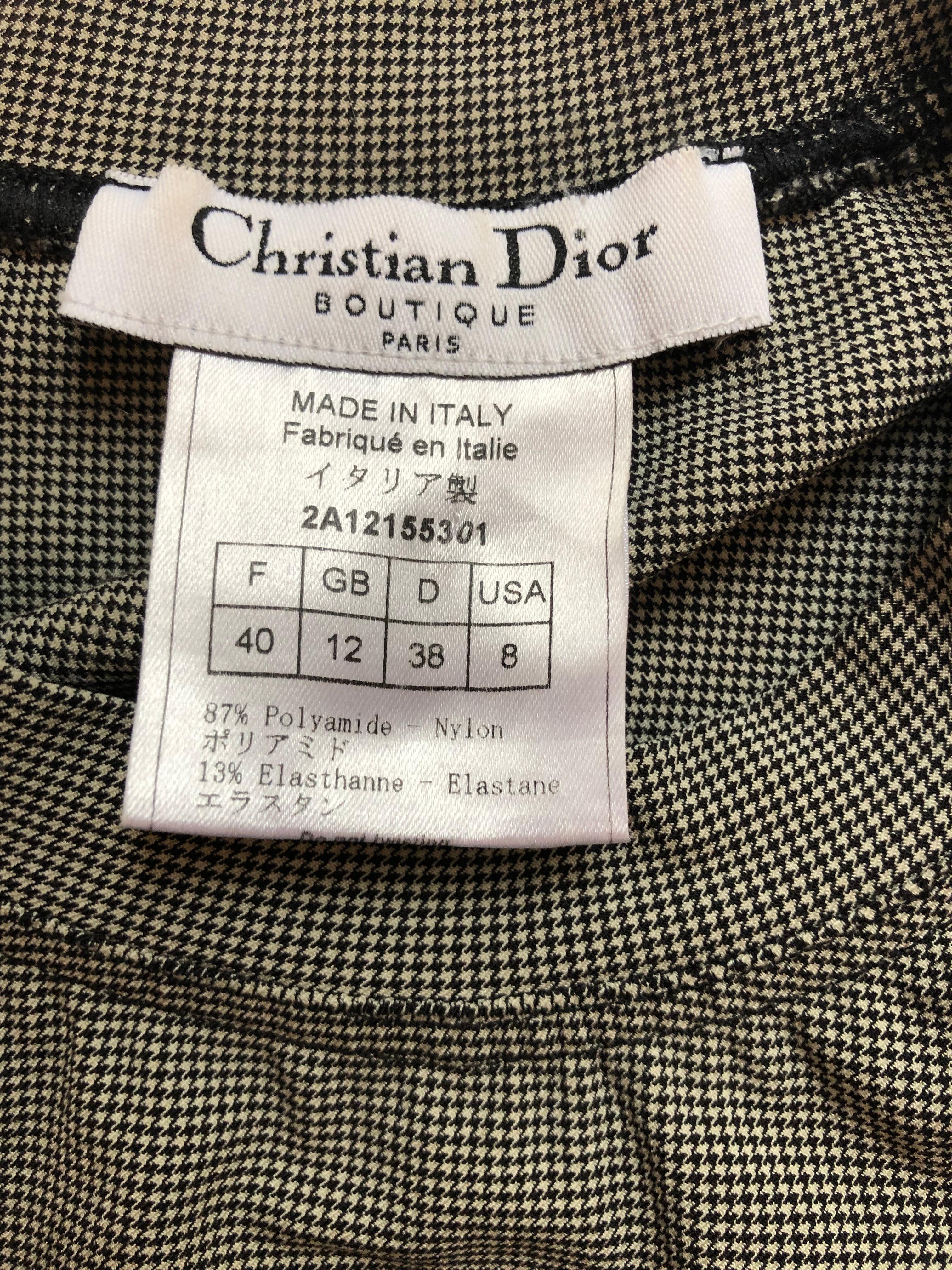 This is a Collector piece from the 2004 collection for Dior by John Galliano hounds tooth Top. The front is adorned with raised J' Adore Dior lettering in black velvet, and the back World Champion 1947.
The piece has been dry cleaned but has a few