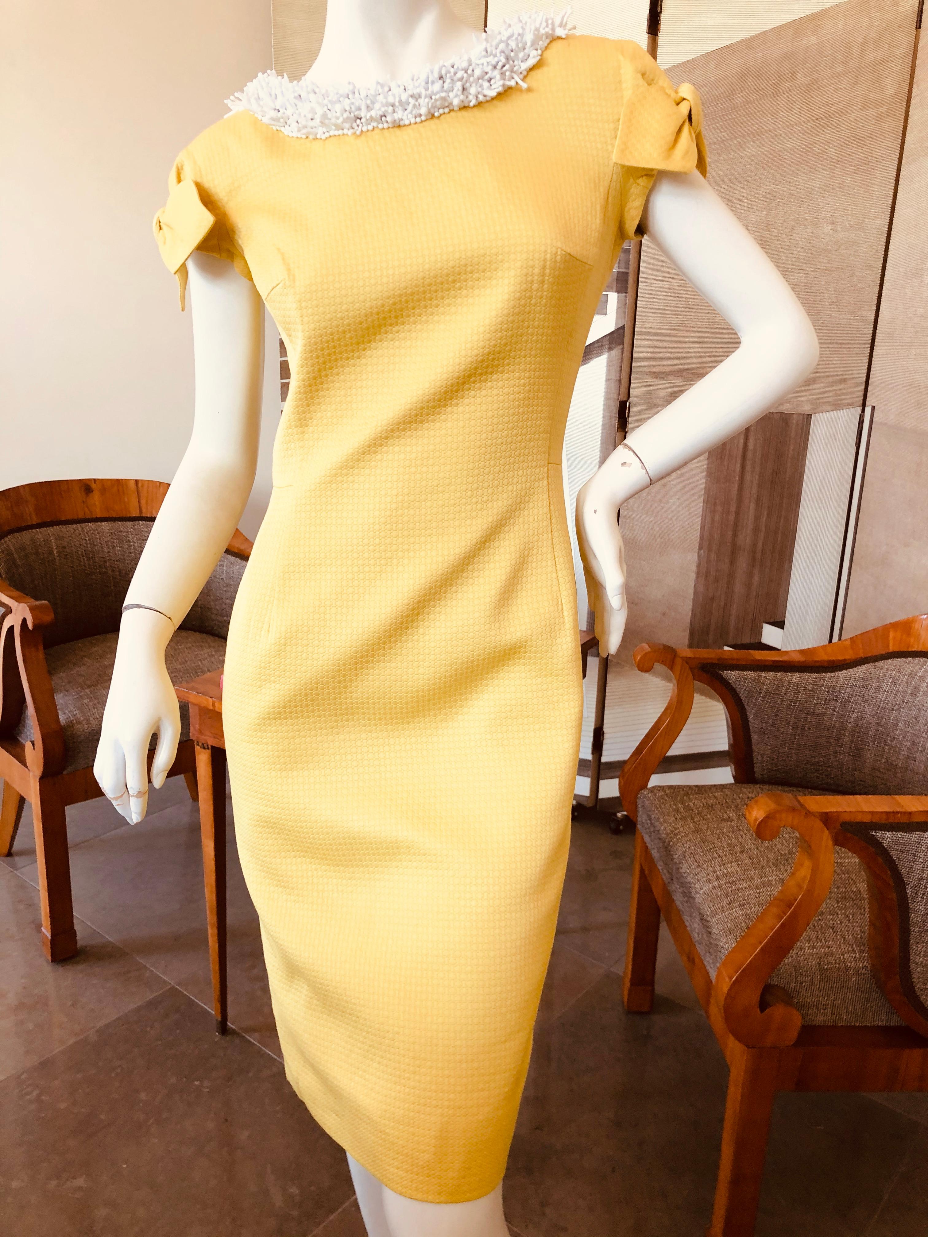 Christian Dior by John Galliano '99 Yellow Dress with Bows and White Coral Beaded Collar.
This is so special. The fabric is a cannage pattern, with bows on each sleeve.
Lined in silk, the necklace collar really is exceptional.
 Size 38
  Bust 36