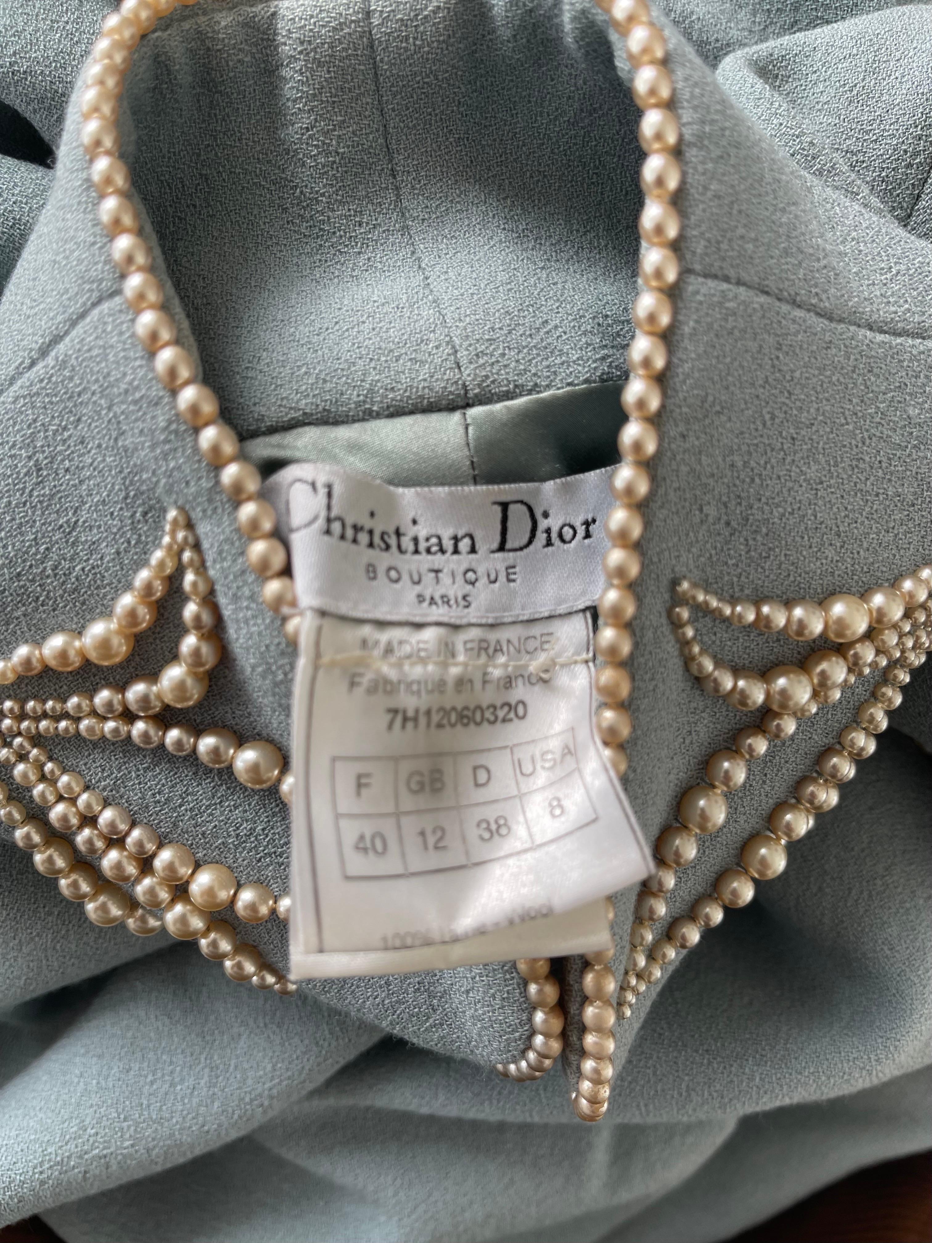 Documented CHRISTIAN DIOR by JOHN GALLIANO A / W 1997 light blue vintage cheongsam style dress ! Features a soft lightweight wool with a luxurious silk lining. Pearl buttons up the side that lead across the bust, ending at the neck. 
This is a