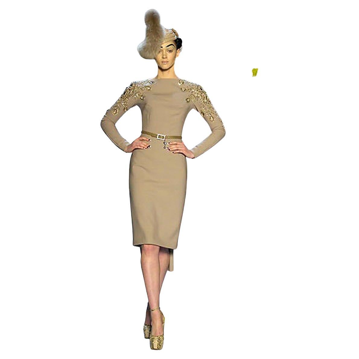 The 2007 Dior collection by John Galliano celebrated the 60th-year-anniversary of the Christian Dior glamourous fashion legacy.  An updated 21st century style homage to the House of Dior.  

Features long sleeve bateau neckline in camel wool  with a
