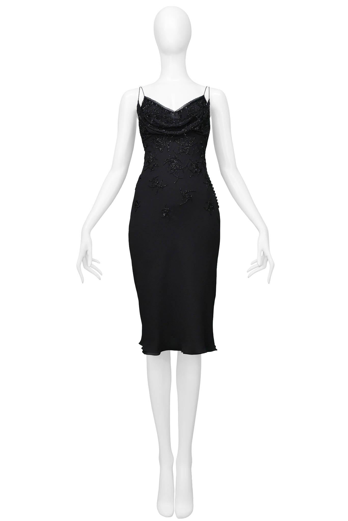 Resurrection Vintage is excited to offer a vintage Christian Dior black silk dress featuring beading all along the dress, multi-button closure down the side, lace trim on the top of the dress, and two shoulder straps on each side.

Christian