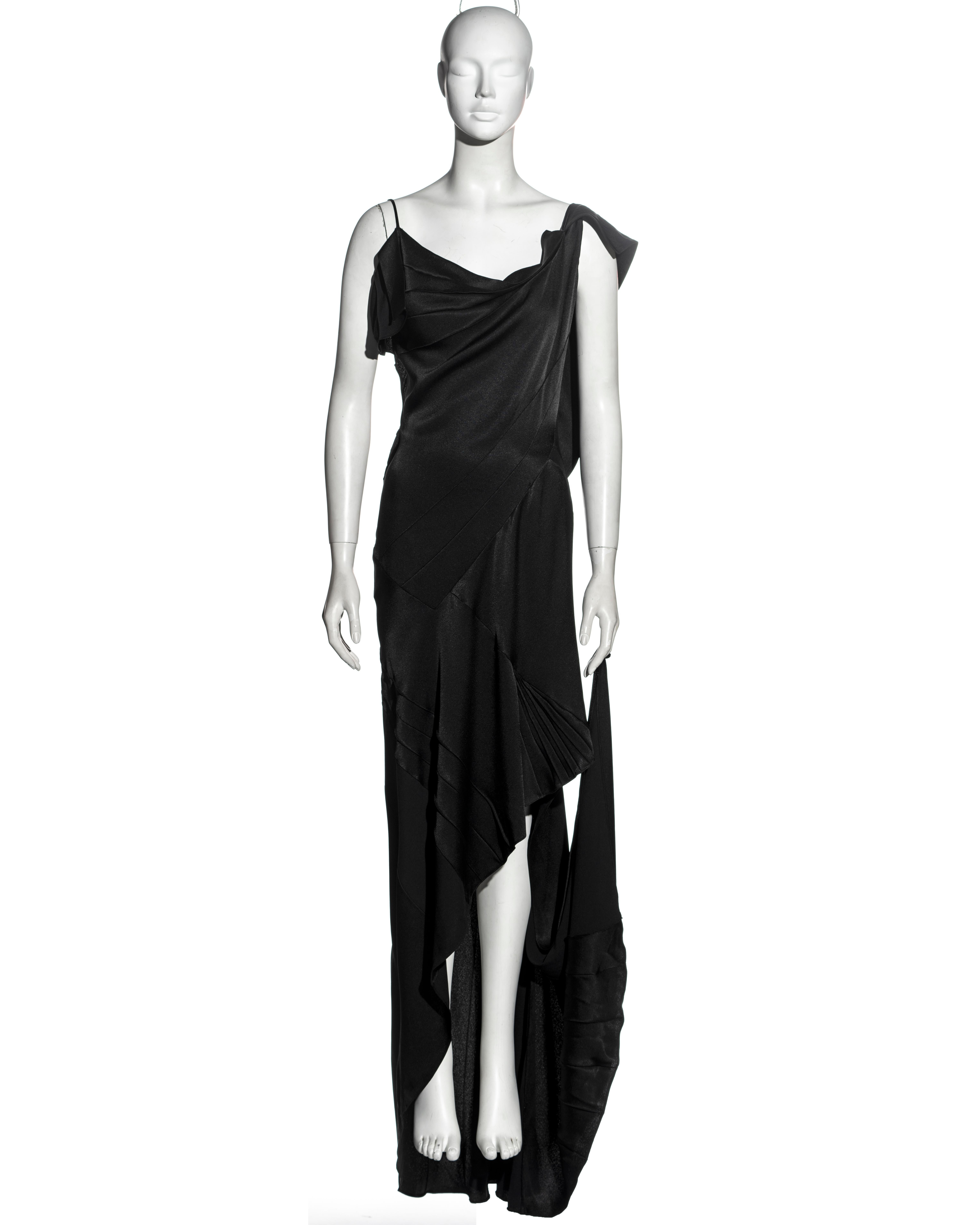 ▪ Christian Dior black satin-backed crepe bias-cut evening dress
▪ Designed by John Galliano 
▪ Draped bodice with cowl neck
▪ Low back 
▪ Accordion pleated panels 
▪ Asymmetric hemline
▪ Floor-length skirt with train and dancing loop
▪ A custom