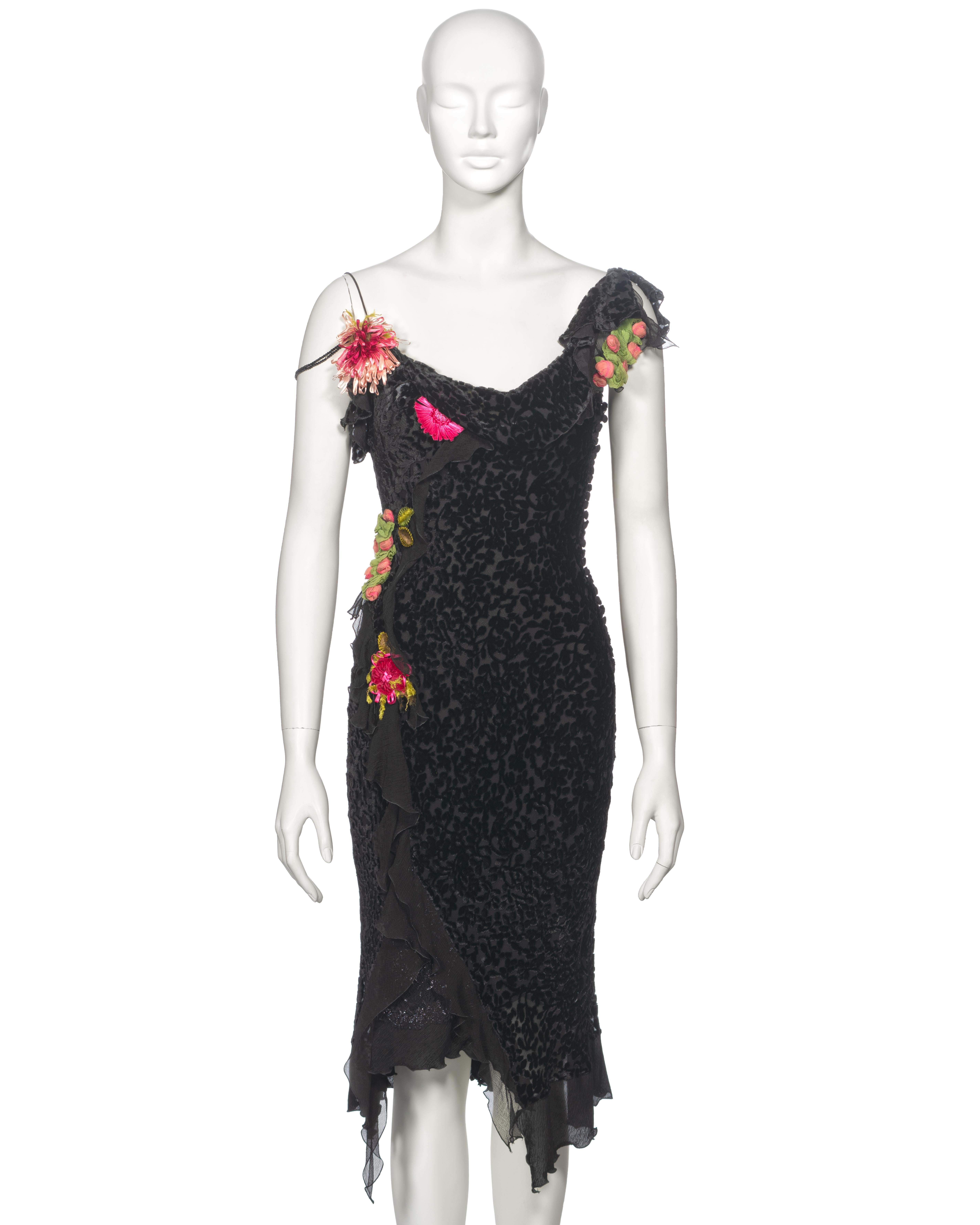 ▪ Archival Christian Dior Cocktail Dress 
▪ Creative Director: John Galliano
▪ Fall-Winter 2003
▪ Black devoré velvet
▪ Silk chiffon frills
▪ An assortment of 3D floral appliqués 
▪ Cowl neckline 
▪ Side button closure with multiple self-fabric