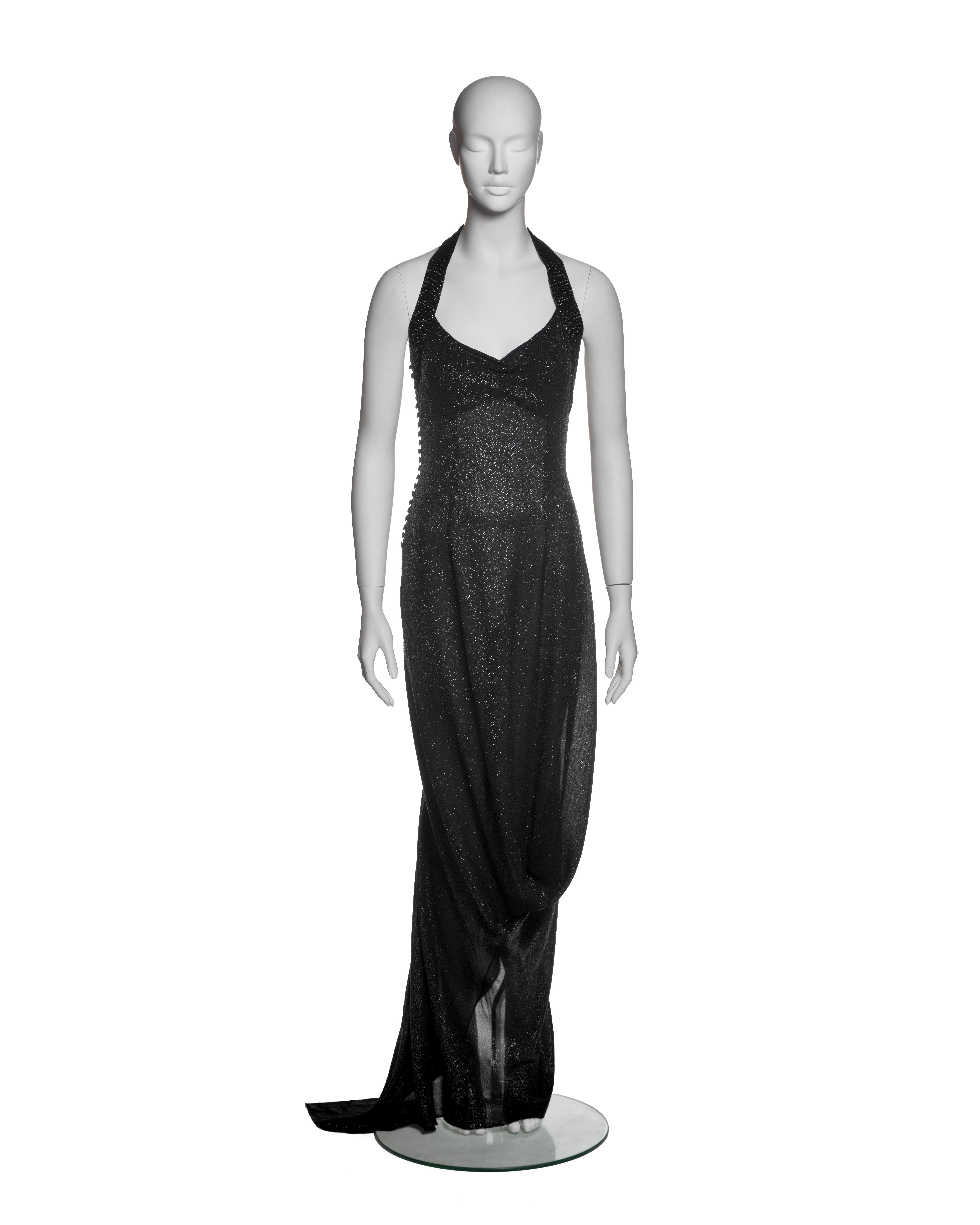 Christian Dior by John Galliano evening dress, Fall-Winter 1999. This halter-style gown is constructed from a semi-sheer black viscose fabric with a woven metallic scalloped motif throughout. The halter strap is fully encrusted with black beads,