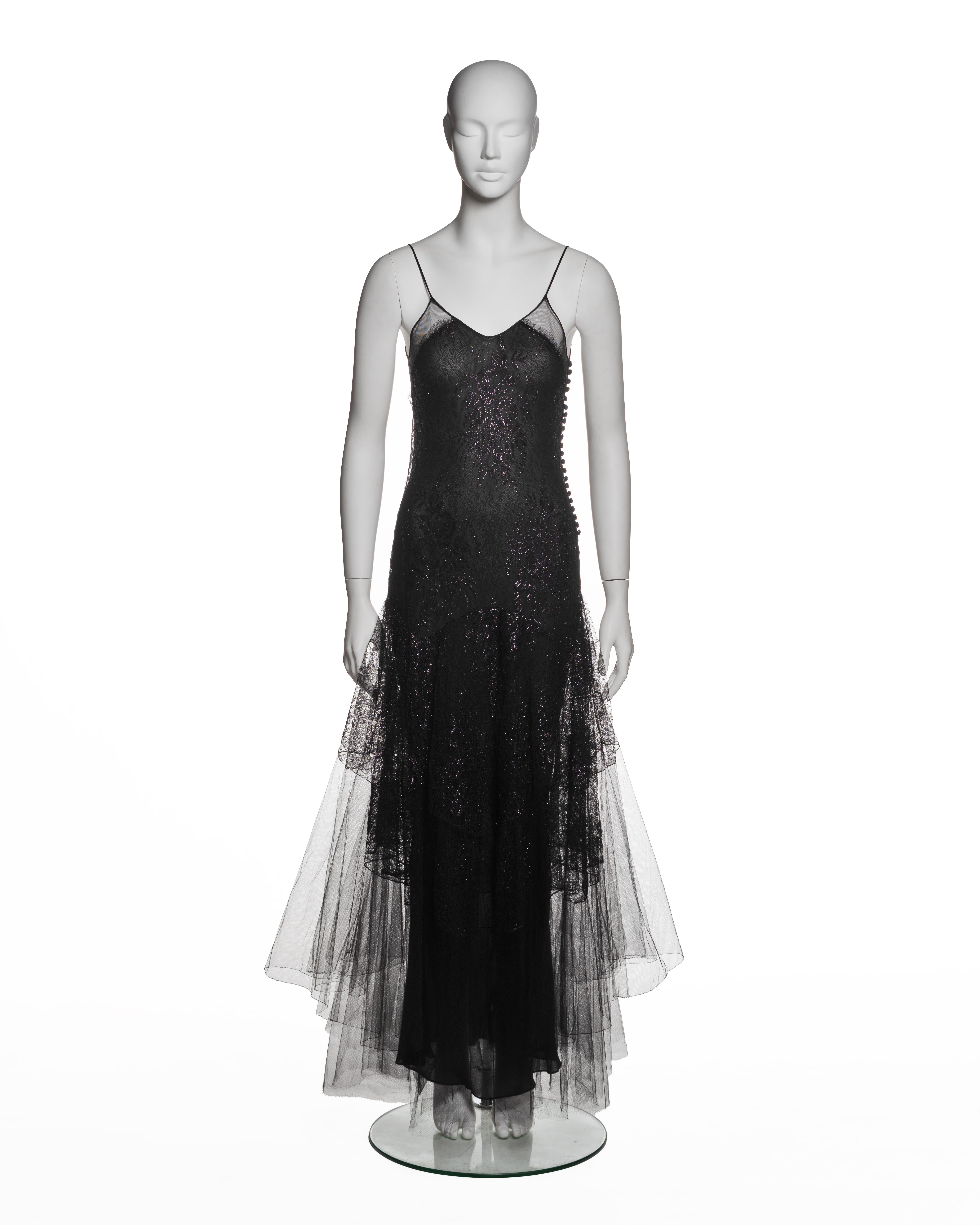Christian Dior by John Galliano, Fall-Winter 2002 evening dress constructed from black lace with layered black tulle. The garment features a fitted bodice with a V-shaped neckline and thin spaghetti straps. Sheer mesh panels are integrated at the