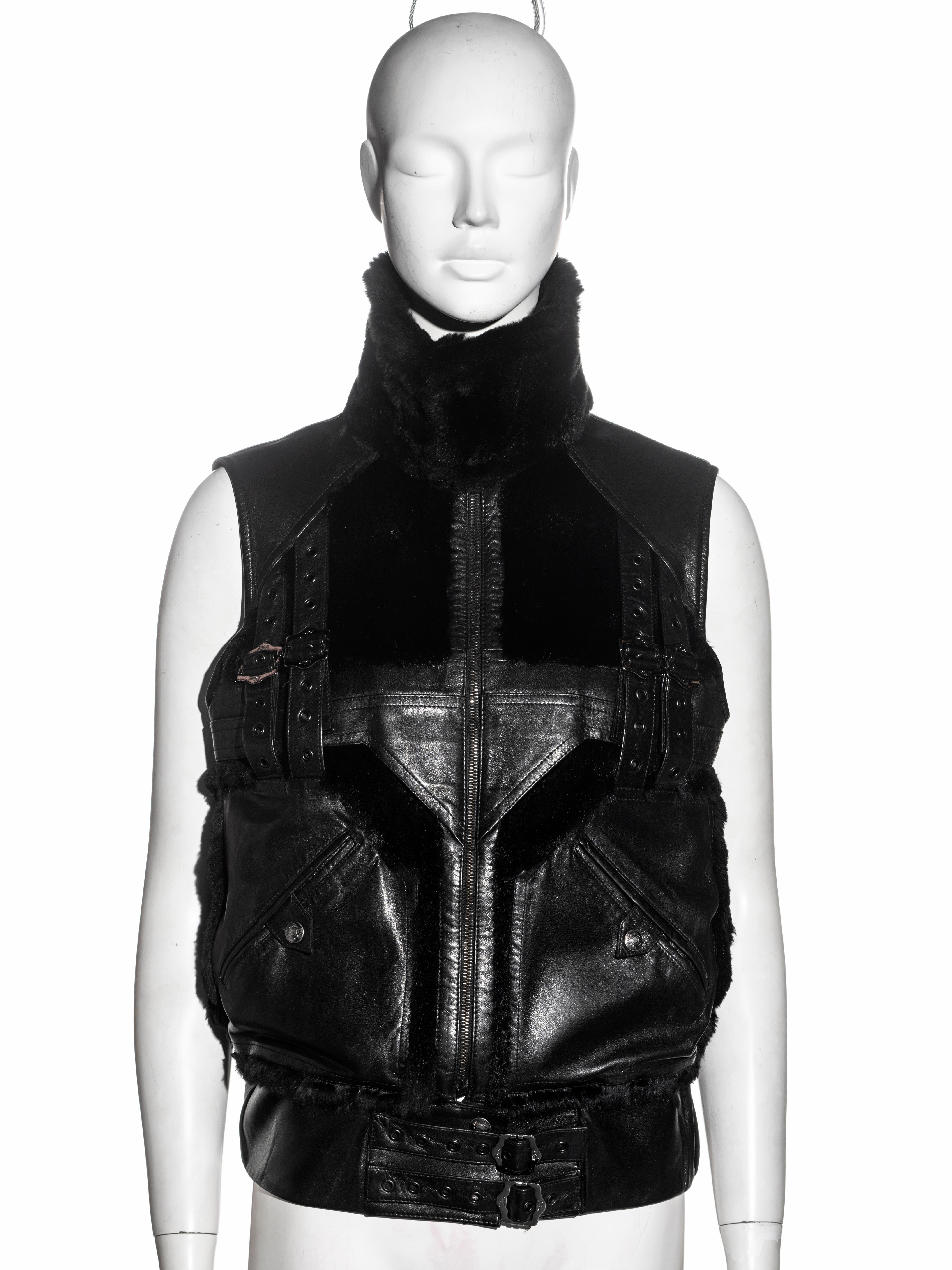▪ Christian Dior gillet 
▪ Designed by John Galliano
▪ Black lambskin leather and rabbit fur 
▪ Bondage straps with metal grommets and buckles 
▪ FR 36 - UK 8 - US 4
▪ Fall-Winter 2003
▪ Made in France