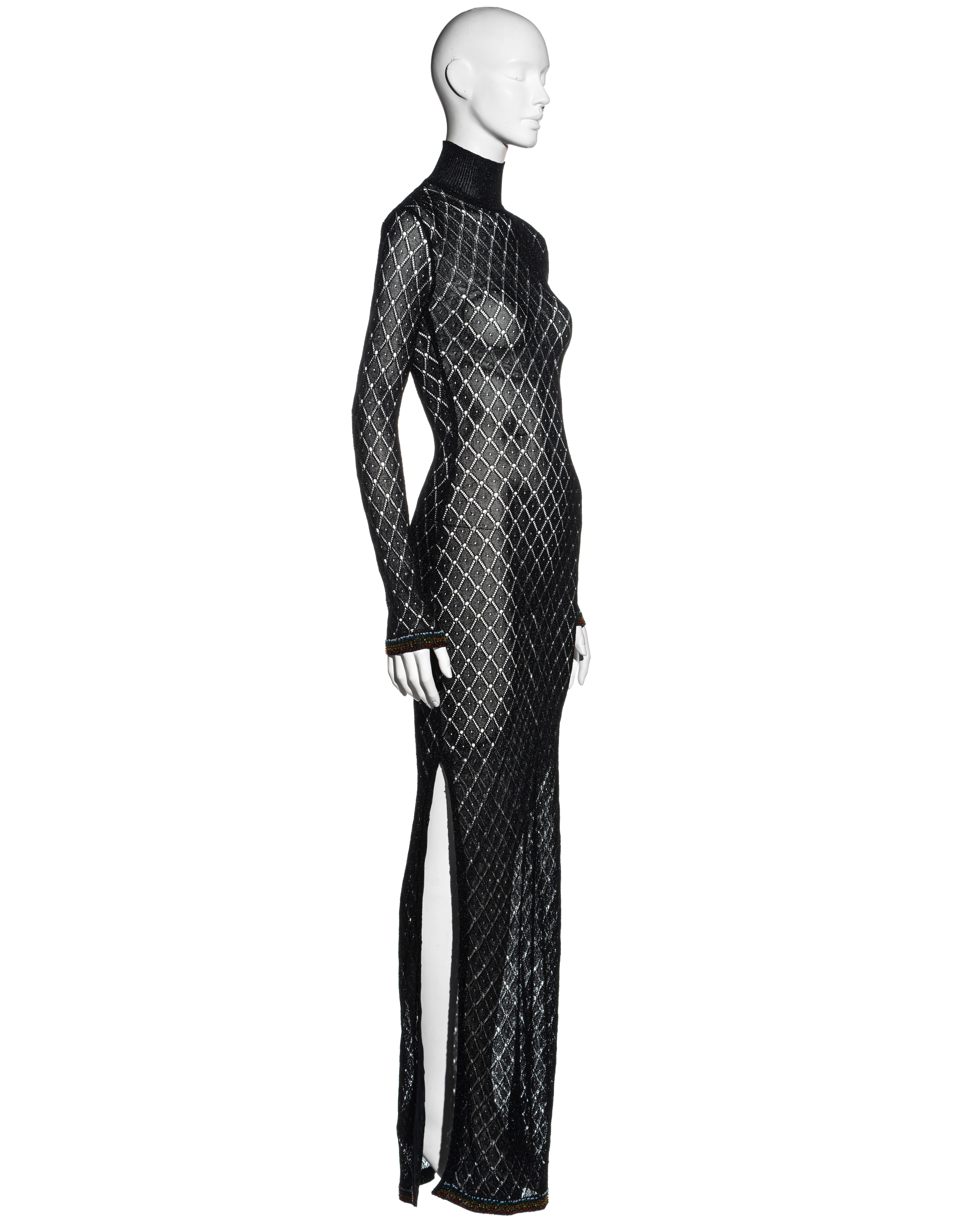 ▪ Christian Dior black open knit maxi dress
▪ Designed by John Galliano 
▪ Turtleneck 
▪ Open-knit in a fishnet pattern
▪ Long fitted sleeves 
▪ High leg slit 
▪ Multicoloured beading around cuffs and hemline 
▪ Sold with matching underdress
▪ FR 38