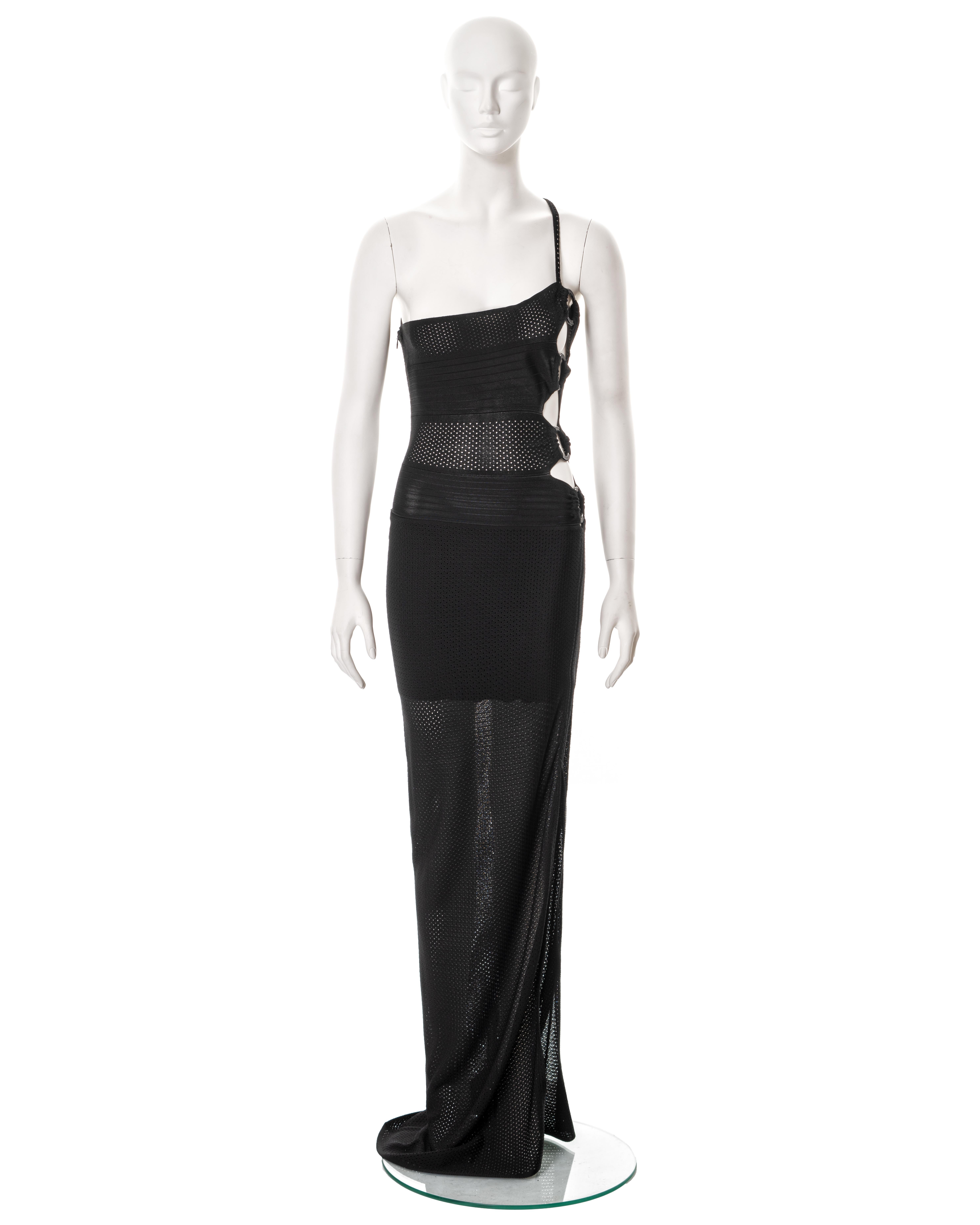 ▪ Christian Dior evening dress
▪ Creative Director: John Galliano
▪ Spring-Summer 2002 
▪ Constructed from black perforated viscose 
▪ Asymmetric neckline with single shoulder strap
▪ Cut outs to one side of the bodice with four large plastic rings