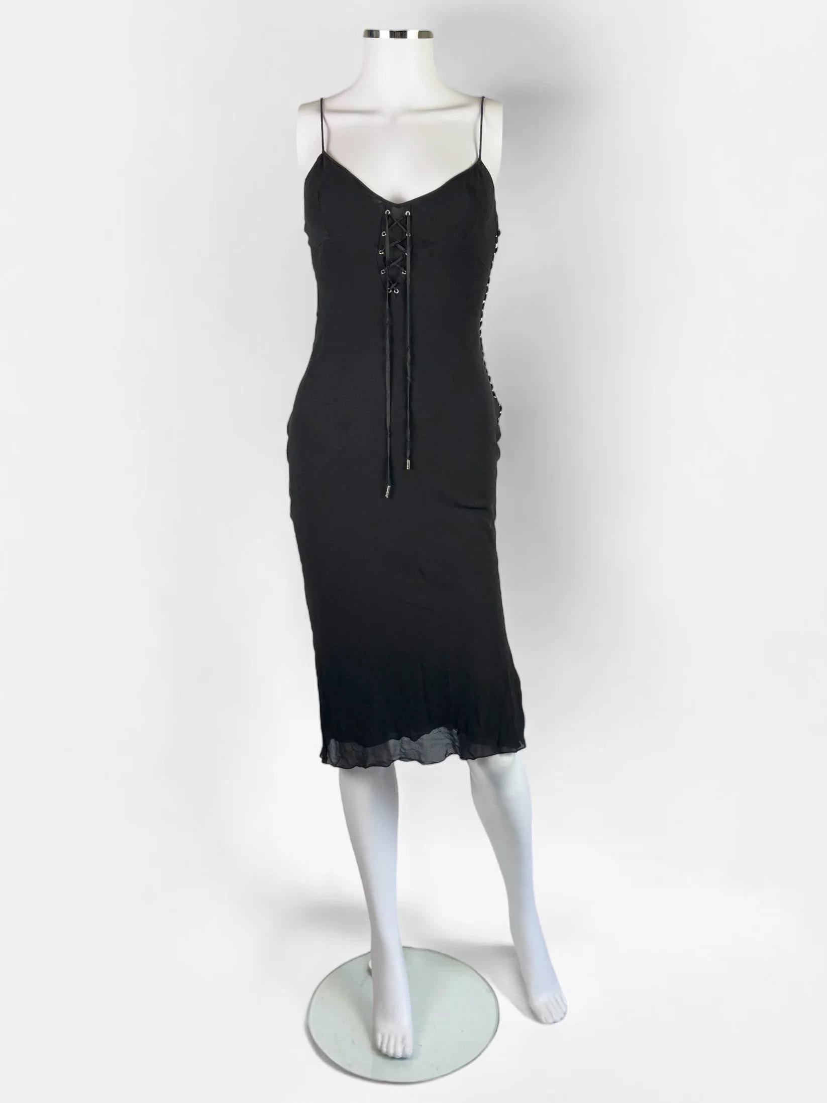 Christian Dior by John Galliano black silk dress, early 2000s (most likely 2003)
Tie up front
Does up with matching silk buttons along one side
Mid length
Thin spaghetti style straps
Black colour with an almost anthracite / charcoal tone depending