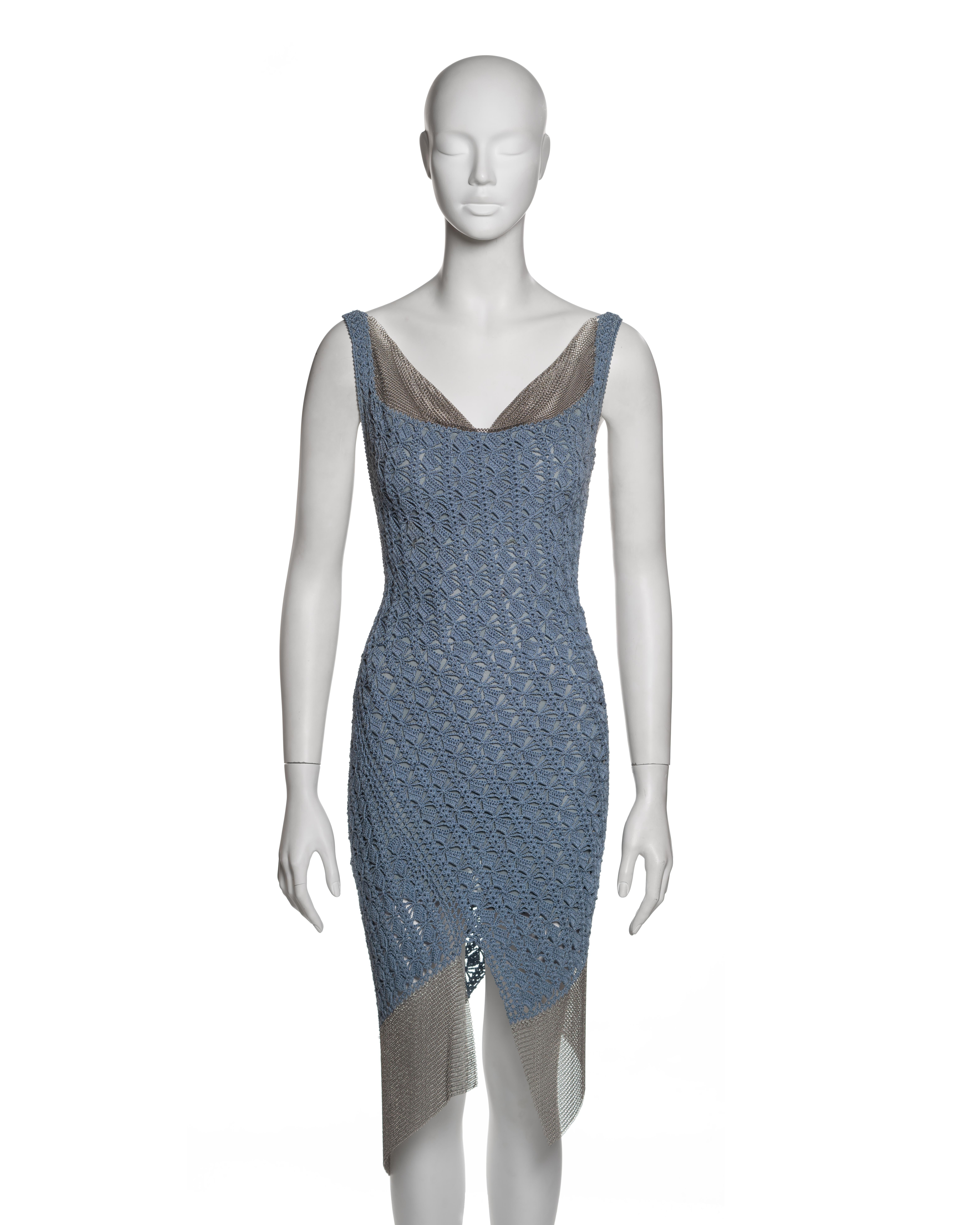 This Christian Dior dress from the Spring-Summer 2001 collection, designed by John Galliano, combines hand-crocheted textile with industrial chainmail, reflecting the designer’s fusion of historical craftsmanship with modern materials. The fitted