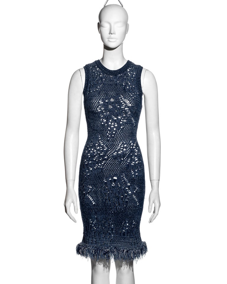 ▪ Christian Dior blue open-knit bodycon dress
▪ Designed by John Galliano
▪ Crew neck 
▪ Knee-length
▪ Various knitted techniques used to create a shredded appearance to the fabric
▪ Hemline designed to imitate frayed denim 
▪ Sizing is flexible due