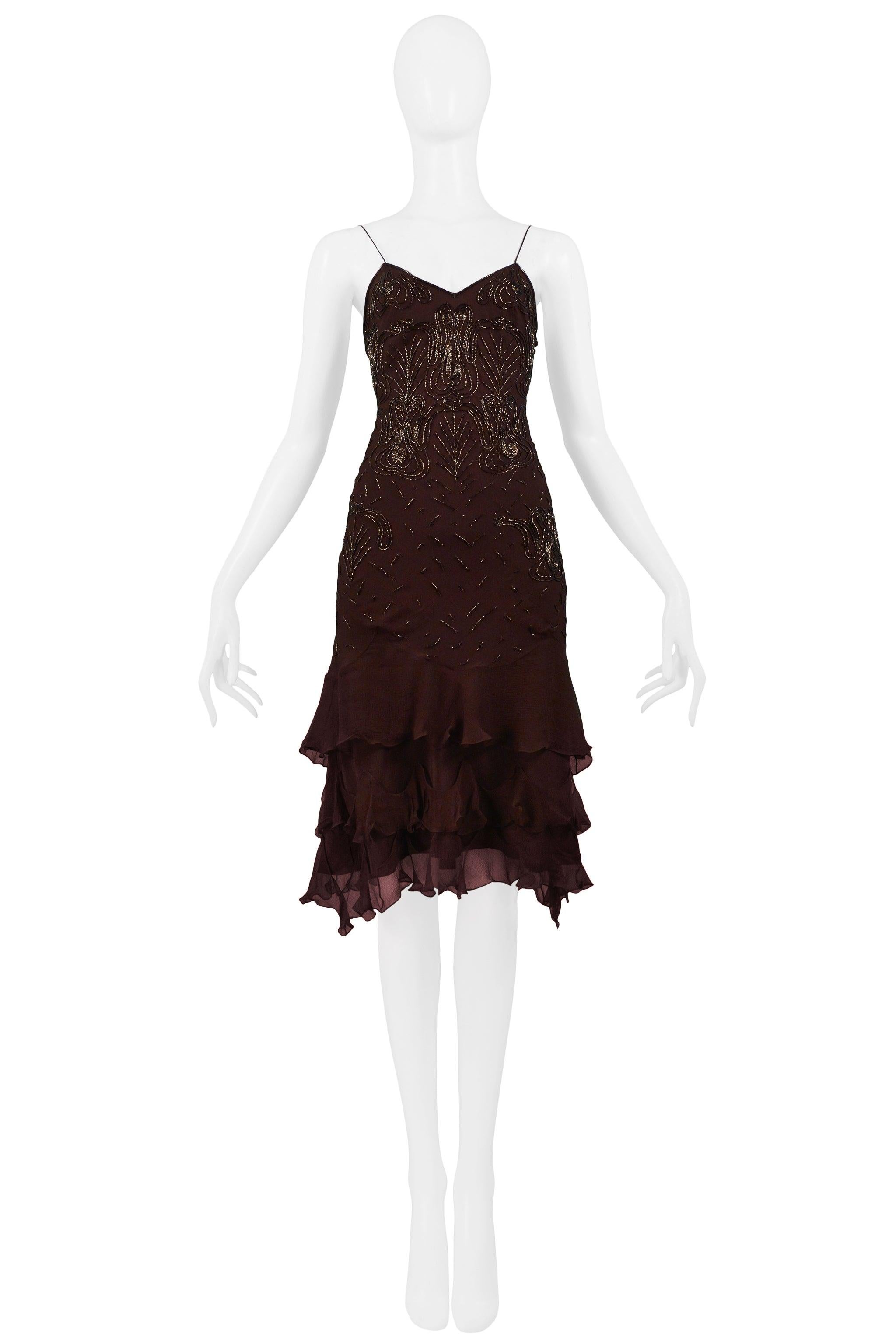 Resurrection is excited to offer a vintage Christian Dior by John Galliano brown silk dress featuring a sweetheart neckline, spaghetti straps, tiered ruffles at skirt, and swirled beading throughout. The dress fits like a classic slip dress.