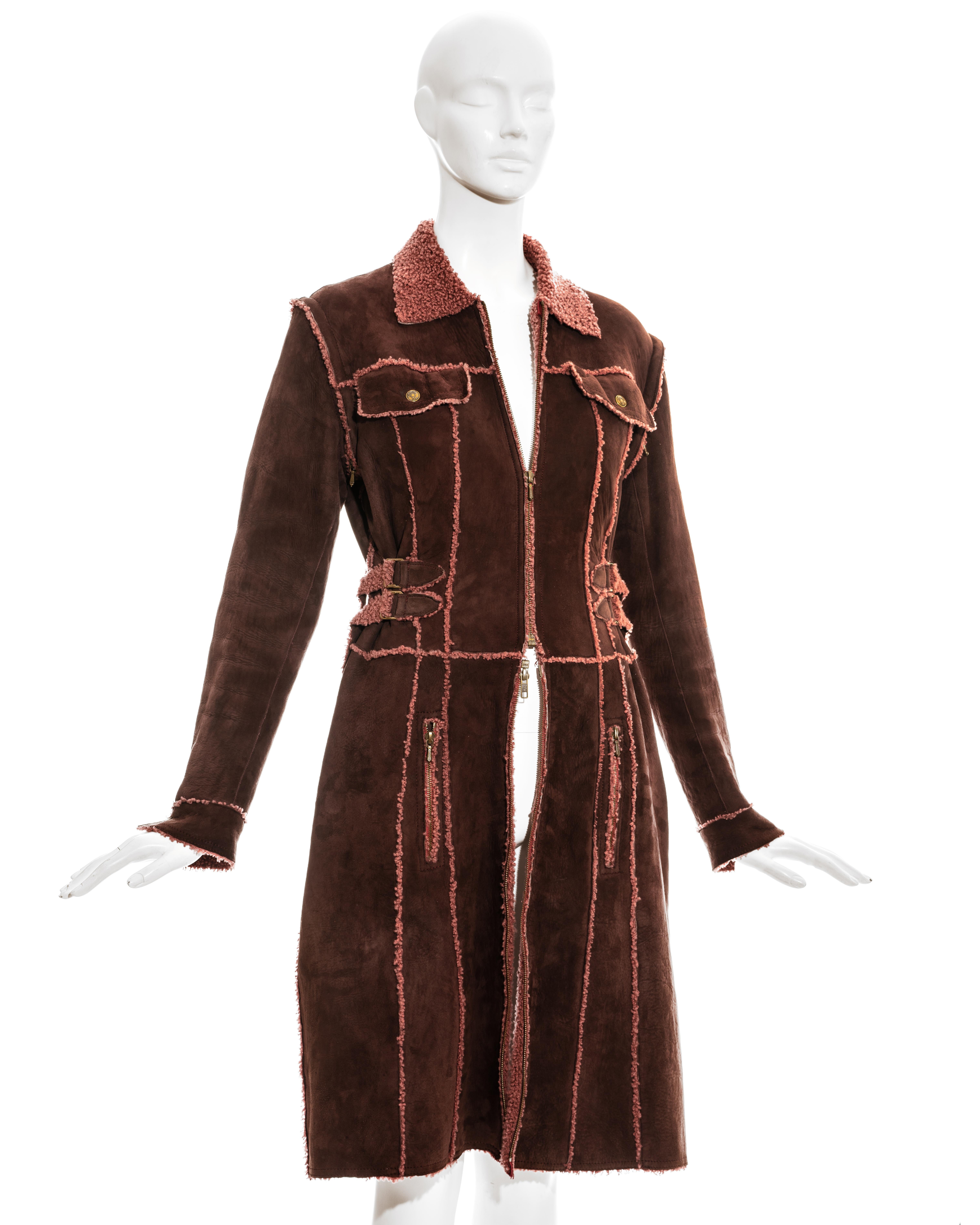 Christian Dior by John Galliano Burgundy shearling mid-length coat with double-ended zipper, detachable sleeves and adjustable buckle side and back fastenings. 

Fall-Winter 2000