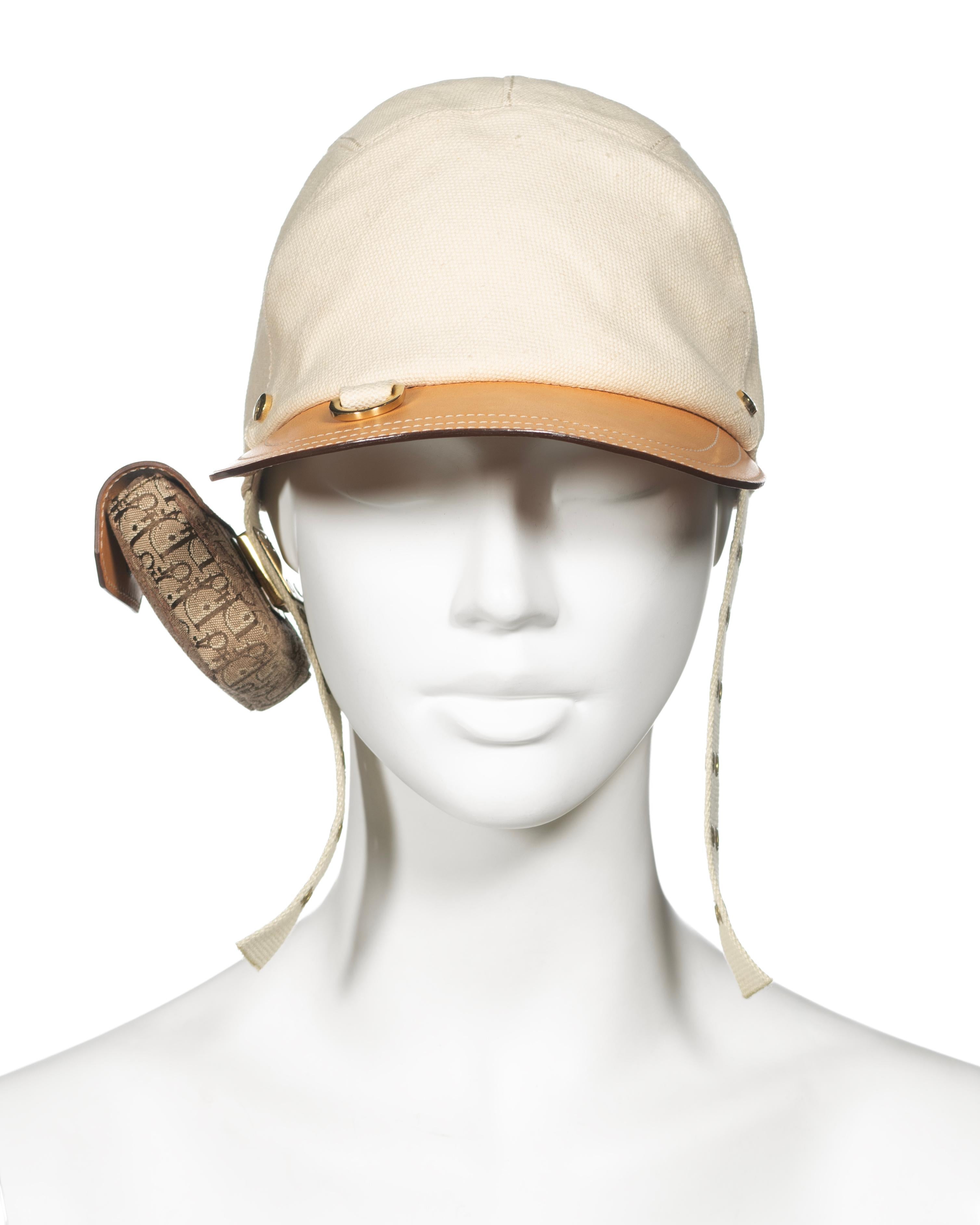 ▪ A Rare Christian Dior Cap
▪ Creative Director: John Galliano
▪ Spring-Summer 2002
▪ Crafted from robust cream cotton canvas
▪ Tan leather visor featuring cream contrast stitch trim, adorned with a gilded gold D-ring reminiscent of horse saddle