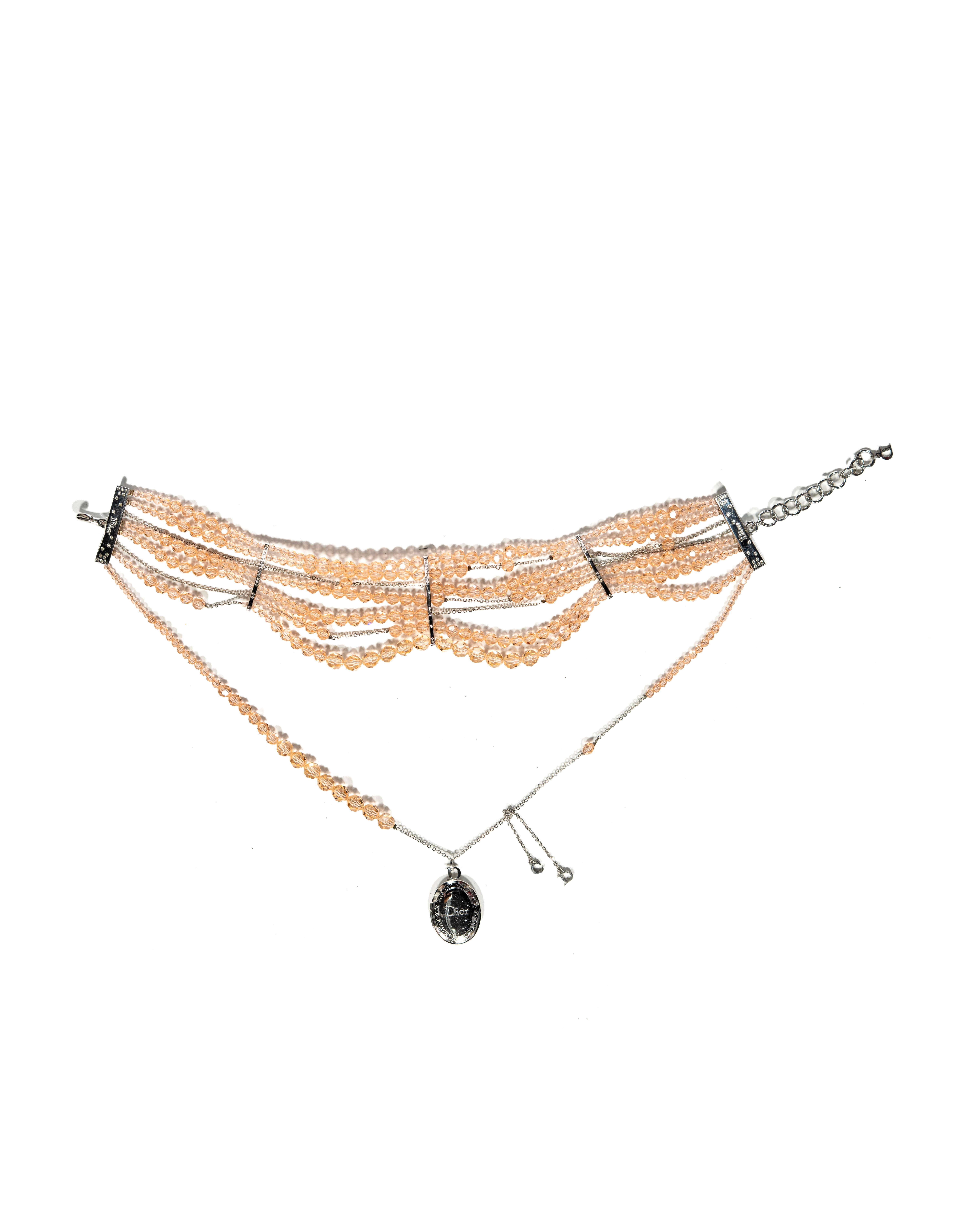 ▪ Archival Christian Dior Distressed 'Masai' Choker Necklace 
▪ Creative Director: John Galliano 
▪ c. 2004
▪ Sold by One of a Kind Archive 
▪ Embellished with seven strands of clear peach faceted glass beads
▪ The centerpiece showcases an