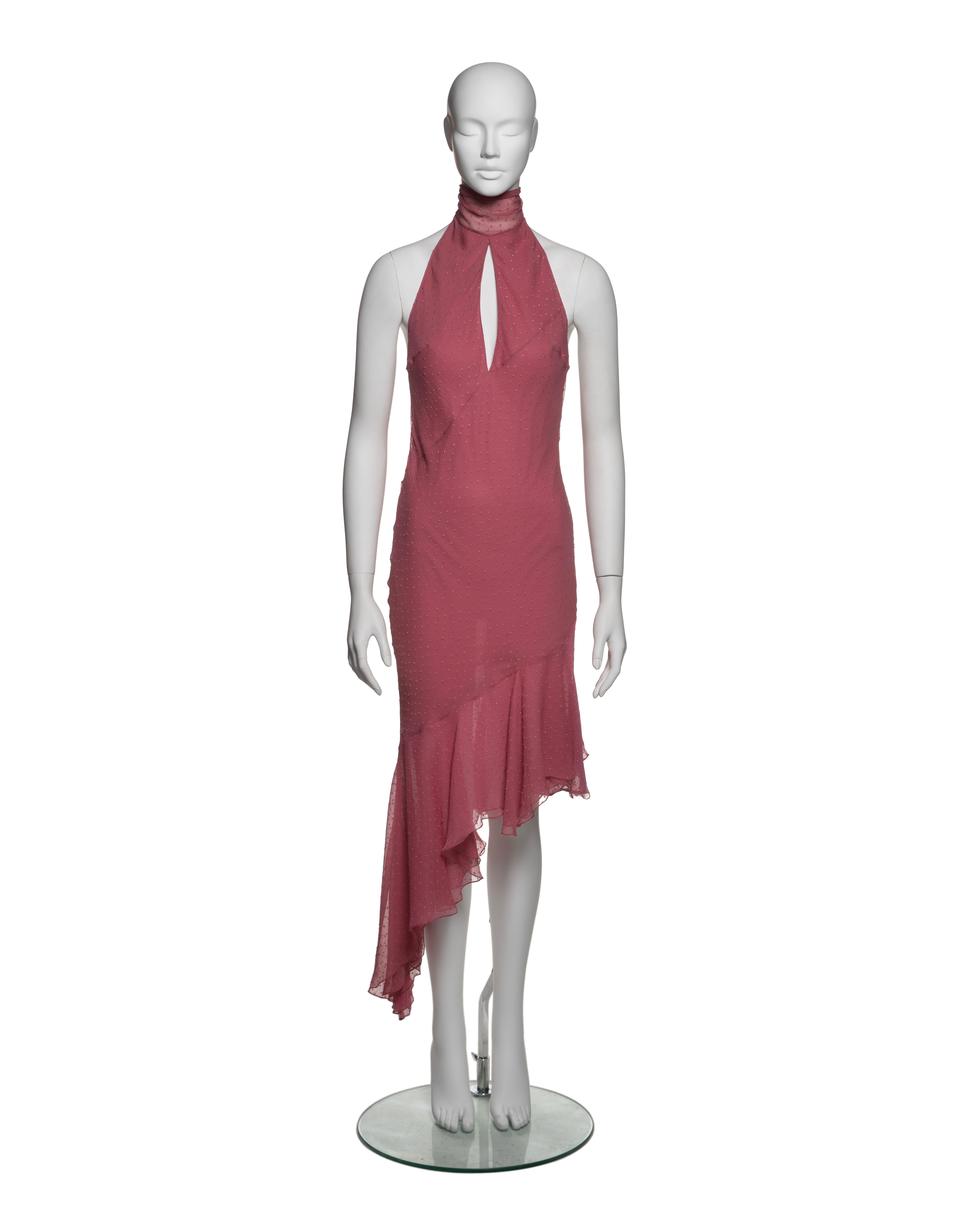 This Christian Dior by John Galliano dress is crafted from dusty rose silk chiffon with an embroidered Swiss dot pattern. The halter-neck design features a keyhole opening at the front, adding a subtle detail. The back is open, with two long silk