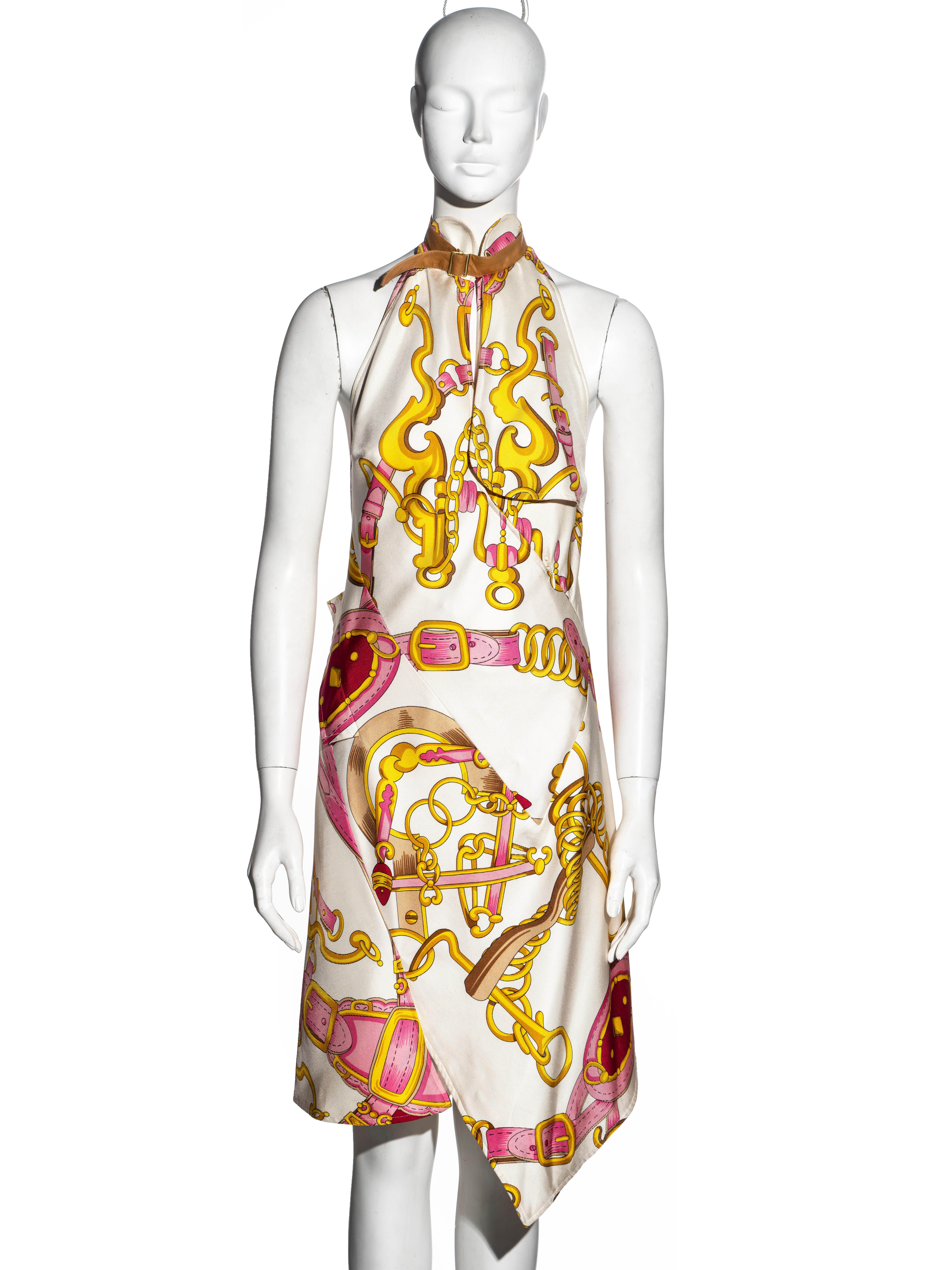 ▪ Important Christian Dior evening dress
▪ Designed by John Galliano
▪ Equestrian printed silk twill in pink and yellow with an ivory base
▪ Tan leather strap at the neck 
▪ Open back
▪ Bias-cut 
▪ Asymmetric hemline 
▪ Charmeuse silk lining
▪ FR 40